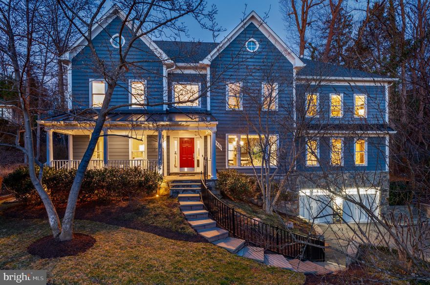 With breathtaking sunset views, 5400 Mohican Rd is a beautiful custom home built by Renaissance Homes that has been thoughtfully refined over the years. The interior offers soaring ceilings, beautiful hardwood floors, oversized windows, crown moldings, and exceptional craftsmanship throughout. The spacious 9,600+ square foot floor plan gives the home an incredible flow for entertaining and everyday living, while giving optionality with a first floor bedroom suite and dedicated playroom/den.  The home sits on a private half acre lot and is surrounded by gorgeous landscaping, a bespoke rear yard and sports court.  It also conveys with a coveted family membership to Mohican Pool!
The gracious foyer sets the tone of beautifully finished interiors with the formal living and dining room on either side. In the formal living room, a double-sided fireplace connects to a richly appointed library, wrapped in custom built-ins and textured grasscloth walls. Across the foyer, the sun drenched elegant dining room flows seamlessly to the kitchen through the butler’s pantry. 
At the heart of the home, the two-story great room offers soaring 19-foot ceilings and dramatic arched windows, illuminated by a pair of Restoration Hardware chandeliers. French doors open directly to the rear patio, creating an effortless indoor-outdoor connection. The renovated kitchen blends beauty and performance with crisp white and gray cabinetry, Carrara quartz and black granite countertops, and professional-grade appliances from Viking, Sub-Zero, and Bosch. Three skylights flood the informal dining area with natural light, while the convenient back staircase provides ease for everyday living.
Upstairs, the primary suite unfolds as a private retreat just beyond the upper landing. The vaulted bedroom is anchored by a large arched window and a two-sided fireplace shared with the adjoining sitting room, where an infrared sauna creates a spa-like sanctuary. The luxurious bath features dual vanities, a freestanding Sansiro soaking tub, a Carrara marble steam shower, and three walk-in closets with ample storage. Completing this level are three additional bedrooms including one with an en suite, two more that are connected by a Jack-and-Jill bath, and a convenient laundry room. 
The lower level is an entertainer's dream with a recreation room that is centered around a stylish bar with custom shelving and a library ladder that adds a touch of architectural charm. Behind double doors, a temperature-controlled wine cellar accommodates up to 3,000 bottles. A fitness studio, media room, bonus room, and half bath offer both places for the kids and adults. The additional bedroom, full bathroom, and direct access to the front, make it the perfect in-law or au-pair suite. Finishing the lower level is direct garage access, which has been upgraded with a durable epoxy floor and an EV charger for modern convenience.
Equally impressive are the home’s thoughtful systems and amenities, including ADT security, a Generac generator, and built-in speakers throughout the main level. Outside, the landscaped grounds include a flagstone patio with a Lynx grill and fire pit anchors the outdoor entertaining areas, while a sports court and turf play spaces invite recreation. Exterior speakers, lighting, irrigation, and drainage systems ensure comfort and ease.