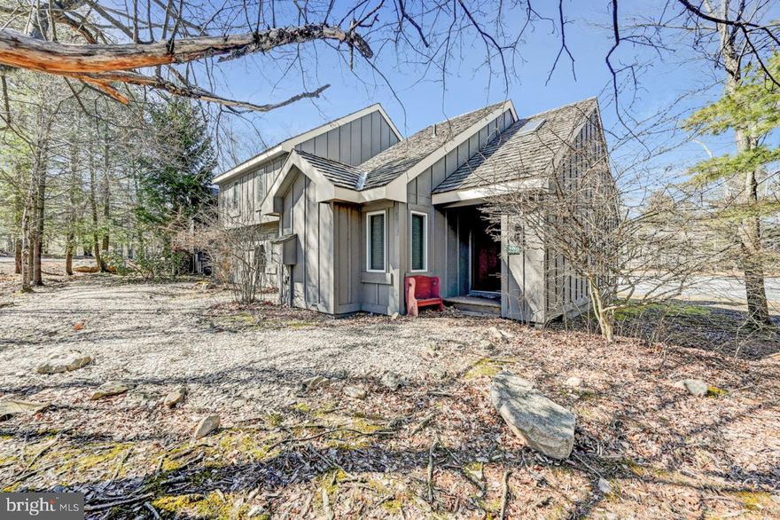 Stunning, End Upgraded Mountain Retreat featuring enhanced interior lighting, newer doors and windows, granite kitchen tops, serene water views, and path to the ski slopes. Sold fully furnished and truly turn-key. Cozy up by the fireplace with pellet stove on cold winter nights. Main level offers 1 bedroom and full bath, while the upper-level sleep loft with half bath and soaring cathedral ceilings adds charm and flexibility. Enjoy modern convenience with an electronic front entry lock. Perfect for primary residence, vacation home, or short-term rental. Located in the heart of the 4-season Pocono Mountains — the mountains are calling! Community water and sewer, with HOA covering exterior maintenance.