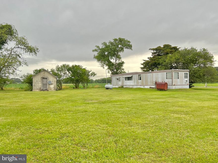 2 bedroom 1 bath trailer on a peaceful one acre corner lot. For its size, the home features a large kitchen, dining area, and living room. Home has two modes of heat - propane furnace and an oil furnace (only run once!). Built-ins are featured throughout for ample storage. Lot has two driveways and several mature fruit trees (apple, mulberry, wild cherry). Great location out in the country.

Property is being sold as is. Cash or conventional financing only.
