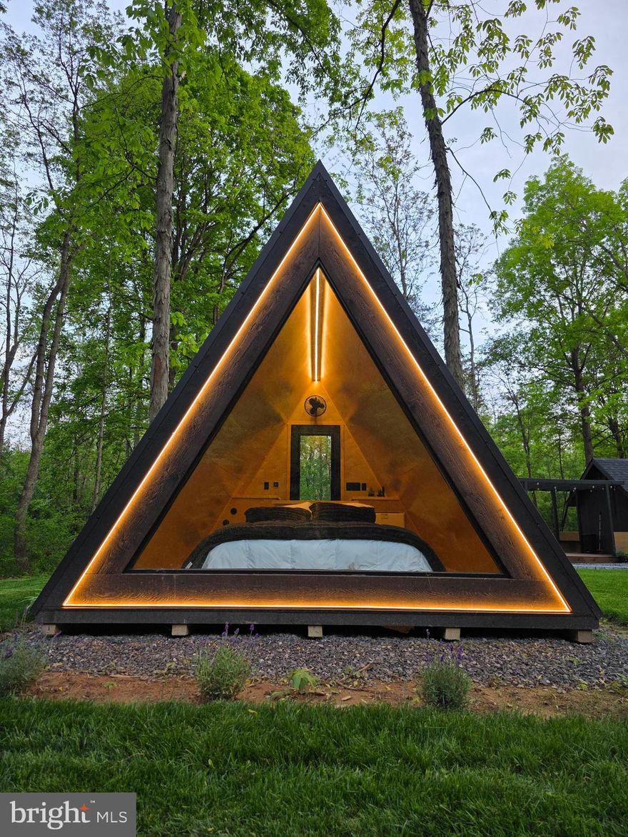 Located just 30 mins from Winchester, VA. This amazing two acre oasis includes two 12x18 glass-front, temperature controlled A-frame sleeping quarters (each with a Queen memory-foam bed and led-lit windows for incredible water views), Victorian-style amenity barn (Wi-Fi, bar, 50” tv, and large windows for that amazing view of the North River), Mountain-side fire pit area, and Facilities building containing two full bathrooms (climate controlled with stand-up glass showers and changing areas in each).

North Rivers Edge was created for those who love to experience nature without the typical sacrifice. Exceptional privacy. Sit on the swings by the river, swim, play with the many outdoor and indoor games, cook on the Blackstone griddle, stargaze with the telescope and sit by the fire in the evenings. 

Entire property landscaped with pest-resistant plantings to deter bug and flying insects. See documents section for list of property and location features.