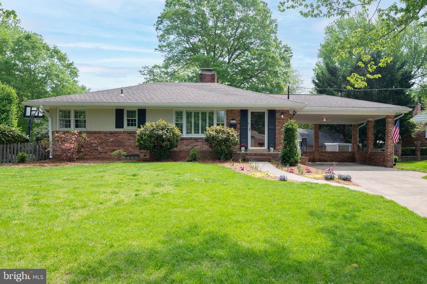 Welcome home to 7911 Bainbridge Road in the highly sought after Hollin Hall Village neighborhood in Fort Hunt. This beautifully updated, freshly painted, and move-in ready home is situated on a large and private corner lot across the street from a  large local park featuring streams, paths, and tons of trees. This home boasts gorgeous hardwood floors throughout the main level,  2 fireplaces (one on the main level and one on the lower level), and a rare basement exit to the backyard. Just past the entryway and hall closet, you will find a comfortable and well-appointed living room with a wood burning fireplace, large and updated windows with custom plantation shutters, as well as additional (slightly bumped out) space that can be used as office space or an eating space. The brightly lit and updated kitchen with stainless steel appliances, gas stove, and granite countertops affords your inner chef plenty of storage with its tall, warm-wood cabinets and a pantry. A separate formal dining room, features stylish built ins, and is perfect for large dinners. Some homeowners have converted the large dining room space into an additional bedroom or office. Two generous bedrooms and a thoughtfully renovated full bathroom round out the main level. There is a huge attic with easy access from the main level hallway, which has pull down stairs, for all of your storage needs. This attic can easily be finished for additional living space. The downstairs family room has been tastefully redone to suit the avid  entertainer, as it has an additional stainless-steel refrigerator, cabinetry, and a wine fridge. The ceiling is a handcrafted tongue and groove tray ceiling with a 1/4 inch reveal and recessed lighting. There are wide plank, hand scraped bamboo floors on the lower level. Beautiful custom built-ins (cabinetry and shelves) accompany the gas fireplace creating a cozy but modern space. The spacious third bedroom  has large windows, carpet, and a generous size walk-in closet.  An updated full bath completes the wonderful living space on the lower level. The laundry room allows for additional storage and contains the walkout door to the backyard. The meticulously landscaped yard and large stone patio are ready for parties! A large, two-car carport boasts additional pull-down attic storage space. Additionally the back has a big storage/work shed (with electricity) which adds to the incredible amount of storage this home offers. Close proximity to many parks, dog parks, libraries, recreation centers, dining, shopping, public transportation, National Airport, the Pentagon, Ft. Belvoir, Ft. Myer, Joint Base Anacostia - Bowling, and Joint Base Andrews Air Field. Easy and very pleasant living inside and out – come envision yourself at 7911 Bainbridge Road! Professional photos will be taken and uploaded next week.  ***Offer deadline on Monday, May 3rd at 5 PM***