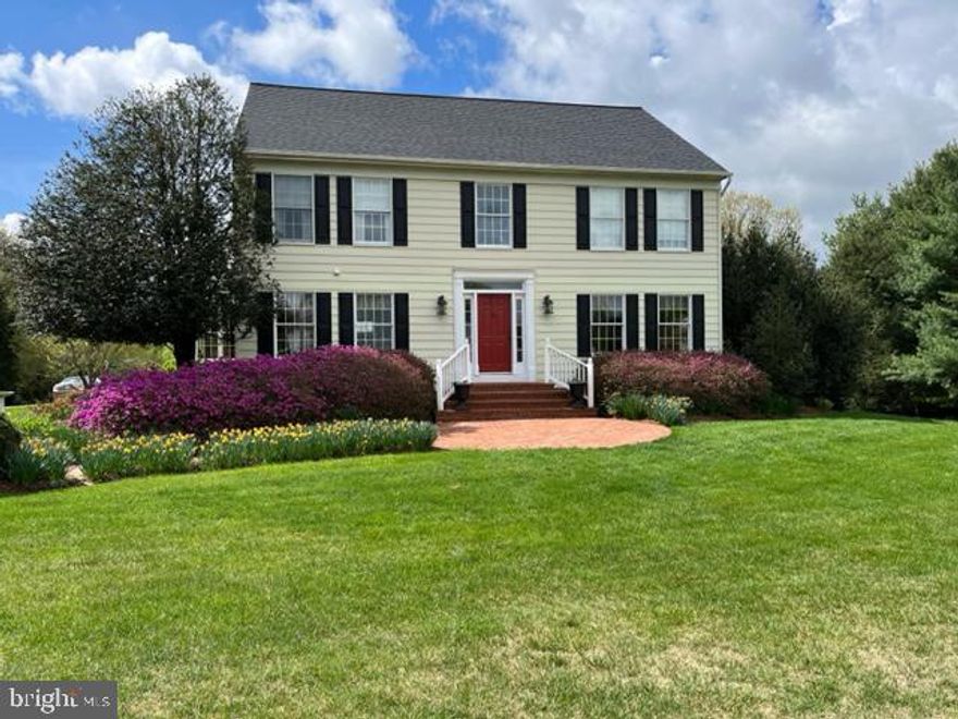 A brick paver patio invites you into this 5,300 + sqft custom colonial boasting serene pastoral views, gleaming hardwoods, exquisite trim, profile moldings, and crafted mill work, a bright 2-story foyer opening to a formal dining room adorned by chair rail trim and crown molding, and a sunken formal living room with French doors stepping to a covered deck. Further down the hallway you find French doors stepping into a study with elegant built-ins and a double desk and an array of sparkling windows, and a relaxing family room showing a raised hearth fireplace with blower planks flanked by built-in bookcases, recessed lighting, and a walkout to a covered deck with access to an 18x13 screened porch. Light and airy u-shaped kitchen and a peninsula island joins forces with the open breakfast room creating a food-focused entertaining space with stainless steel appliances, granite counters, classic silk colored cabinetry, and plenty of windows with a backyard view. An incredible owner's suite presents a 13' cathedral ceiling, 2 walk-in closets, access to the floored attic, secret eaves storage, and a garden bath displaying a skylight, a separate shower with seating, and a jetted tub. Providing a lifestyle of luxury and comfort, this home also features an upper level studio or In-law suite with a private balcony, a full bath, a kitchenette, and tons of additional storage. Retreat to the lower level for more casual gatherings where you find a sprawling rec room with 9-foot ceilings, a game room that is media or theater room ready, an exercise or bonus room with an attached half bath, and a 5x12 walk-in wine cellar and 8x9 open storage. Premier location, this home offers many amenities and is conveniently located only minutes to major commuting routes, shopping, dining, recreation, and both the Baltimore and Washington metro areas.