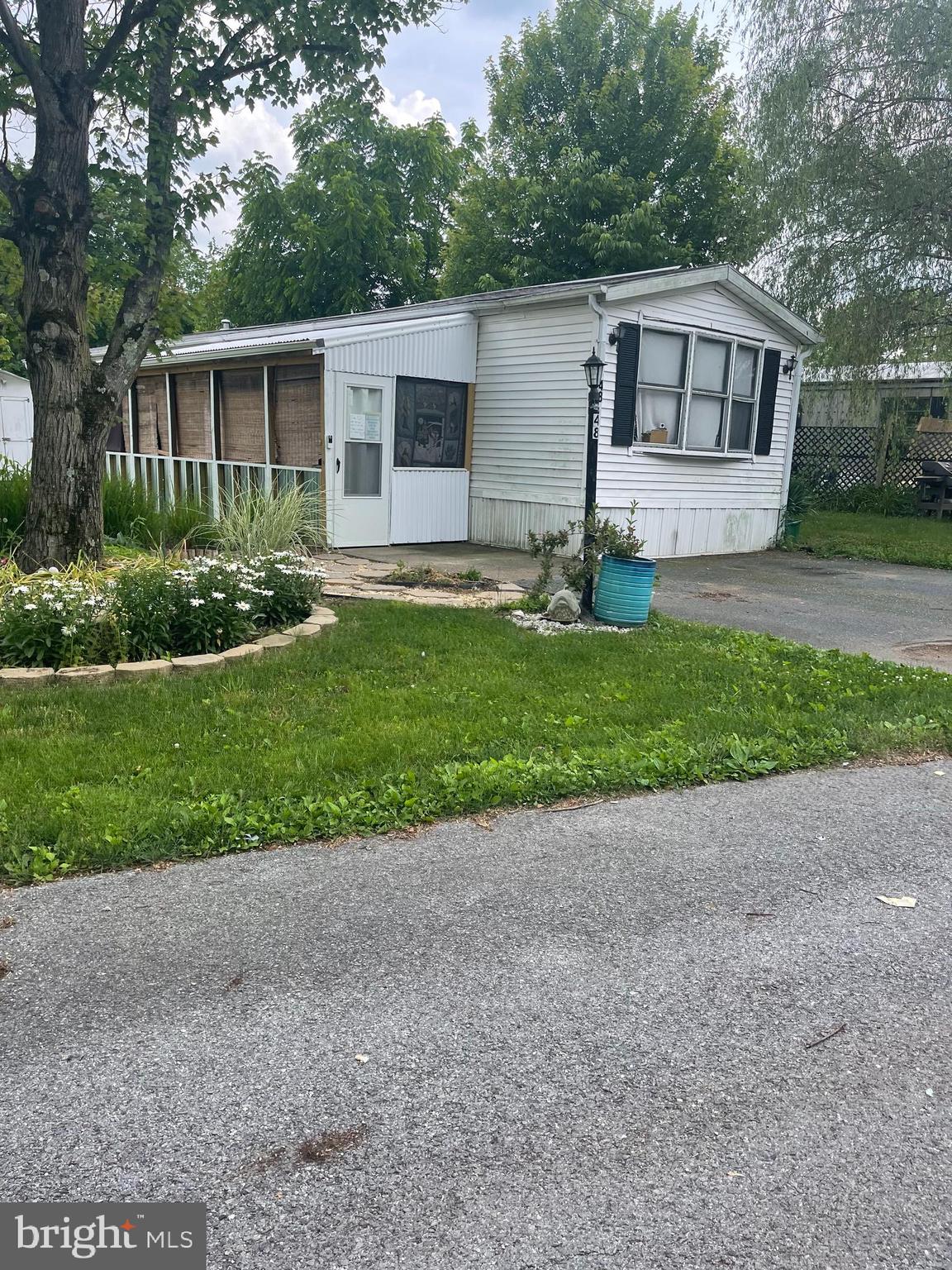 Welcome to 48 Aspen Lane in Country Manor West community! This charming mobile home features two spacious bedrooms and two full bathrooms, perfect for comfortable living. Enjoy cooking in the updated kitchen. Relax on the screened porch, ideal for peaceful mornings and evenings. Stay comfortable year-round with central air and gas heat. Conveniently located, it's just a short drive to the pike and within walking distance to the creek and Appalachian Trail. Lot Rent is 630 a month including water and trash BEING SOLD AS IS
