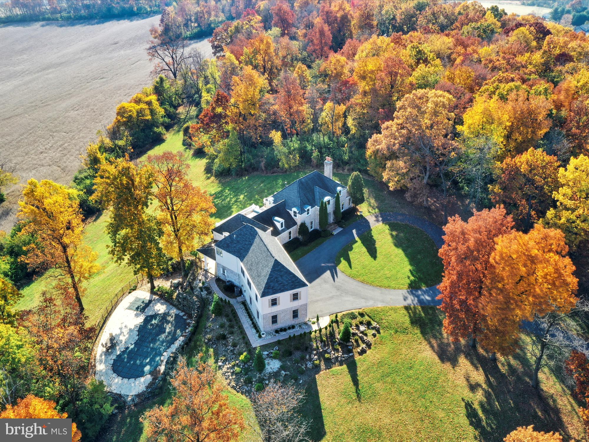 Welcome to 1123 Cross Keys Rd located in the rolling hills of Bern Township, Pennsylvania. Everything to do with this home exudes tranquility from coming up the winding driveway, to your first impression of the home with its marvelous circular driveway. Upon entering the home you will be greeted by a vaulted foyer with a grand staircase. Off of the foyers is the formal living room with wood burner fireplace. This room is incredibly spacious and will make those winter nights peaceful and cozy. On the opposite side you will find a room dedicated to music - featuring a piano. Off of this room you will enter the wide open concept of the dining, kitchen and living room. The kitchen is a chef's paradise and perfect for entertaining. The tall windowed walls in the living room allow you to truly soak in the marvelous view this property has to offer year round. Making your way through the kitchen to the rear of the home you will find an updated butlers pantry with a wet bar and wine fridge. There is an excellently sized dining room with plenty of light, and off of that is an office with another wood burning fire place. This room would make an excellent library, or could be used to suite whatever your needs are! Upstairs are two primary bedrooms - one that was added in the recent addition with an oversized shower and plenty of space in the bathroom for getting ready. The new primary bedroom is spacious, with an additional glass doored room off of it for a work out room, office, or anything you can imagine! The remaining three bedrooms are generously sized, one with an attached bathroom. There is also a flex space perfect for a craft or toy room. The basement is finished allowing even more space for indoor entertaining. There is an area that is current set up as an in home theatre. Outside you have endless opportunities with this sprawling property. The rear patio overlooks the gorgeous pastures below. Additionally there is an inground pool and spa for your enjoyment. All of this and the convenience of location just minutes from Routes 61, 222, and 78.