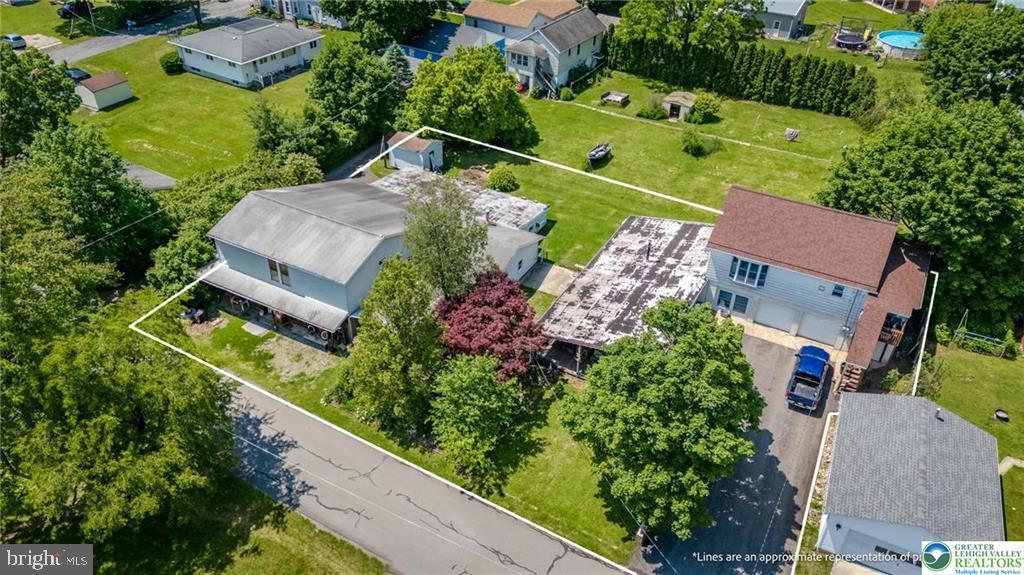 Great 2-3 bedroom home with 3900+ square foot detached 2 story building/ workshop. Don't miss your opportunity to own this unique property! Main floor offers large floor plan with spacious dining room, kitchen, family room, half bathroom and office area. 2nd floor provides an additional family room, second kitchen, full bathroom in addition to 2 bedrooms. Covered elevated 2nd floor deck with patio doors is a bonus! Large fully finished 3rd floor can easily be used as a 3rd bedroom, playroom, office, storage or whatever you choose. Covered front porch and screened in side porch is a great seasonal feature! 2 car attached attached garage also has two indoor storage rooms and a fully enclosed 8x30 foot finished storage room in the rear of the home. 3900 sq ft detached 2-story workshop! Workshop includes large open spaces, high ceilings, and tons of potential! Perfect for mechanics, woodworkers, artists or car collectors! This space has power, flexibility and enough room to bring your hobby dreams to life!! Centrally located just minutes to downtown Lehighton, Routes 209 & 248! Don't miss this rare opportunity and call for your private showing today!