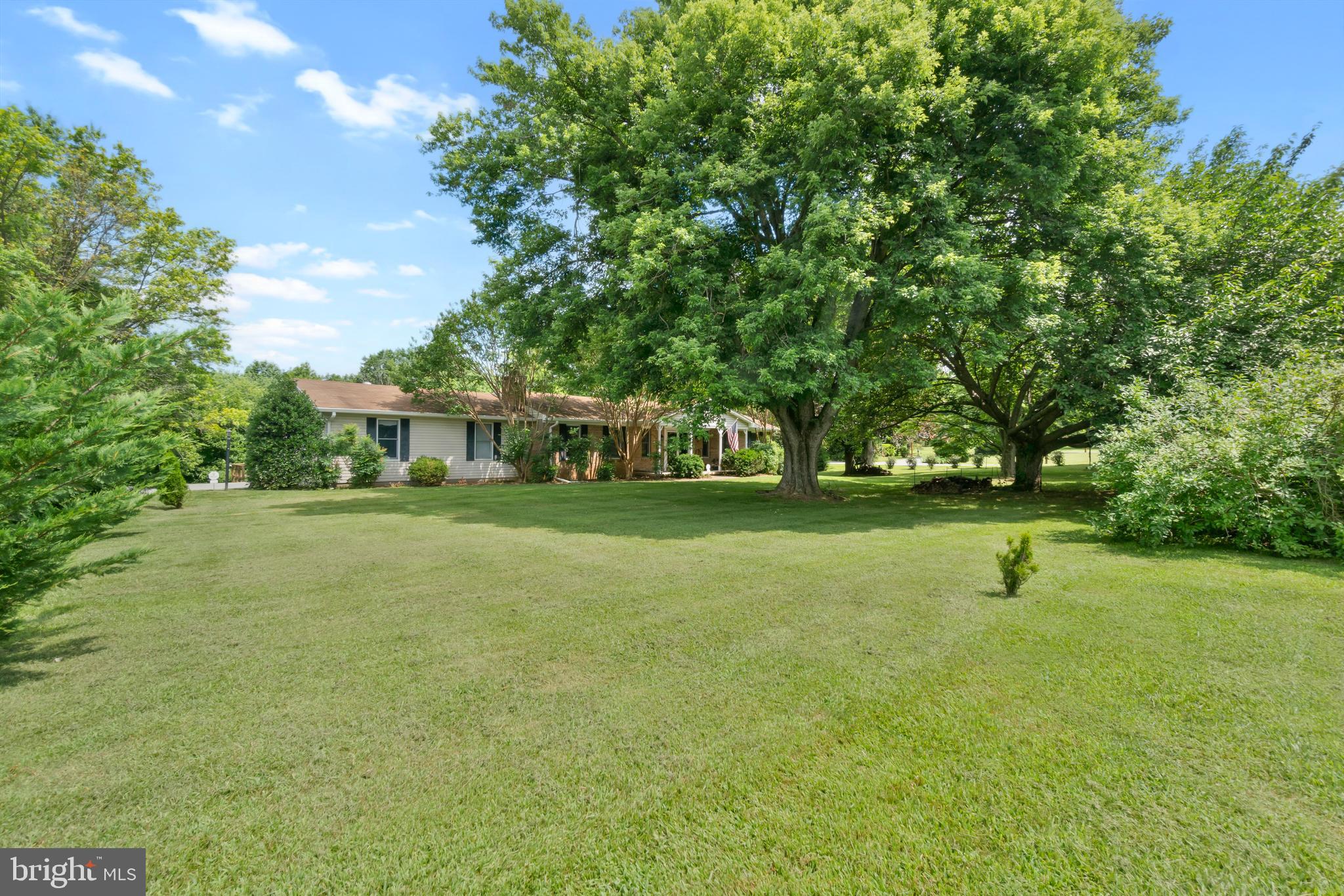 **Best & Final Offers With NO ESCALATION CLAUSES Due by 12 Noon on Tuesday, July 29** Welcome to this rarely available sprawling rancher, ideally sited on a picturesque and level 2.74-acre lot in highly sought-after Monkton. Surrounded by serene views of trees and open farmland, and siding/backing to conservation areas, this property offers a peaceful retreat just minutes from conveniences.
Step through the covered front porch and double entry doors into a welcoming slate-tiled foyer. The inviting family room features a wood-burning fireplace with brick hearth and mantle, flowing seamlessly into the formal dining room with gleaming hardwood floors. The heart of the home extends into two thoughtfully designed rear additions—one showcasing vaulted ceilings, wood floors, and two walls of windows that flood the space with natural light, and the other offering ceramic tile floors, baseboard heat, and direct access to the tiered rear deck—perfect for enjoying the tranquil setting.
The main level includes three generously sized bedrooms, all with hardwood flooring. The primary suite features a ceiling fan and a private ensuite bath. A ceramic-tiled kitchen, two additional full baths, and a spacious laundry/mudroom with garage access complete the main level.
The expansive lower level is partially finished and offers incredible versatility with a large recreation room, flex space, multiple workshop areas, ample storage, and even a potential fourth bedroom. A double-door drive-in area provides ideal storage for lawn equipment or outdoor gear.
Additional highlights include an oversized two-car side-load garage, and exceptional privacy with no rear neighbors in sight. This is a rare opportunity to own a truly special property in a tranquil Monkton setting.
Property will convey as-is as part of an estate sale.
