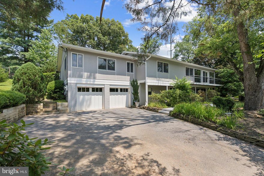 Welcome to 9821 Betteker Lane, a beautifully updated mid-century inspired home nestled on a serene 0.4 acre lot in the sought after Glen Park neighborhood of Potomac. This spacious five-bedroom, three-bath residence offers over approximately 2,700 square feet of finished living space and a seamless blend of MCM inspired architecture and modern upgrades.

The main level features soaring ceilings, expansive windows and a fully renovated gourmet kitchen equipped with Jenn-Air and Thermador appliances, custom cabinetry, and a center island. The open concept living space serves as the heart of the home and connects the kitchen, dining and living room without interruption.

The primary suite is a true retreat with a floor-to-ceiling stone fireplace, large dressing room, and a spa-inspired bath with radiant heated tile floors, as well as direct access to a private patio. Additional highlights include two fireplaces, hardwood floors, recessed lighting, and a fully finished lower level with a spacious family room, guest bedroom/home office, laundry area, and storage.

Outside, enjoy a tranquil backyard with a stone patio ideal for entertaining. An attached two-car garage, newer windows, and updated systems offer added convenience. Located in the top-rated Churchill High School cluster (Wayside ES, Hoover MS), and just minutes from Bethesda, Rockville, and D.C., this move-in-ready home offers the perfect combination of comfort, style, and location.

Public record reflects total square footage of 3,690. 
All measurements are approximate. Property details and square footage should be independently verified, and not used for property valuation.