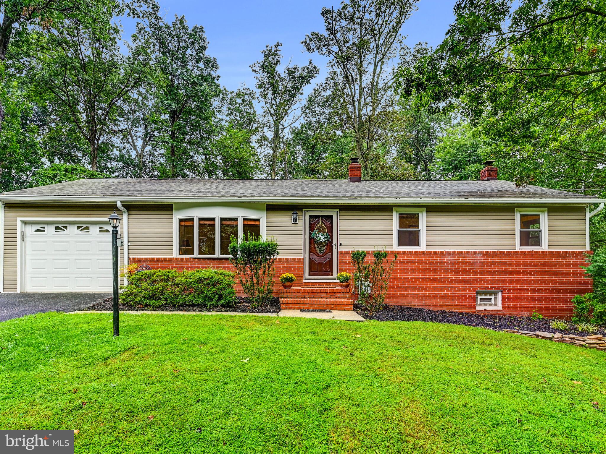 Sykesville/Eldersburg. Privacy is a Plus at this "One of a Kind Gem" in Strawbridge Estates. Charming Rancher on partially wooded half acre lot. Prior to current Owners purchase, this home was expanded with a one car Garage and a main level Family Room with wall of windows facing the woods with a connected party sized screened porch. This Family Room also has a heat producing gas stove. The Kitchen was updated with new cabinetry and some stainless steel appliances. Hard wood flooring in the Kitchen was installed to match the beautiful hardwood flooring throughout the main living level (except LVP in the Family Room). Three Bedrooms and two full Baths on the main level. The lower level features a brick, raised hearth and recently cleaned wood burning fireplace. There is also newly installed neutral color carpet and fresh paint throughout the lower level. A convenient third full Bath along with Storage Room, Laundry Room, Bonus Room, and massive walk-in closet allow for lots of living and entertaining options. This home was built with gas Hot Water Baseboard Heat, Central Air and a whole house fan. There are eleven remote controlled ceiling fans throughout the house. Radon Mitigation was completed in 2009 and Septic cleaned out in 2024. For your convenience, the exterior of the house was just professionally power washed and the gutters cleaned. In the back yard there is a stand alone shed with roll-up door and side entry door for easy equipment storage and post and rail fencing surrounding the entire back yard. 1303 Hillcrest Drive is a short walk to Freedom Elementary and Liberty High School. Lots of nearby shopping and main road arteries are a bonus! This home is move-in ready for the next Happy Home Owner!