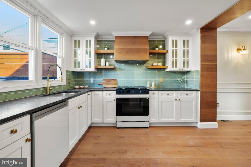 Welcome to 2234 S Clarion Street — a one-of-a-kind boutique residence where bold design meets everyday functionality. This fully customized 2-bedroom, 2.5-bath home delivers a perfect blend of modern luxury, thoughtful craftsmanship, and standout finishes throughout. Step inside to an open and airy main level featuring wide-plank hardwood flooring, elegant wall paneling, and designer lighting that sets the tone for the entire home. Natural light pours through the front windows, highlighting the clean lines and carefully curated details that make this home truly unique. The chef’s kitchen is a statement in both style and function. Showcasing custom cabinetry, sleek stone countertops, and a striking handcrafted wood hood, the space is elevated by a rich green tile backsplash and brass accents. A premium gas range anchors the kitchen, while ample prep space and storage make it ideal for entertaining or everyday living. A stylish powder room on the main level adds convenience and personality, featuring bold designer wallpaper, custom vanity, and elevated fixtures that leave a lasting impression. Upstairs, you’ll find two spacious bedrooms along with a beautifully appointed full bathroom. The finishes continue to impress with high-end tilework, warm brass fixtures, and a clean, modern aesthetic that creates a spa-like feel. The fully finished basement offers exceptional versatility, complete with a additional room and an additional full bathroom—perfect for guests, a private suite, or a home office setup. Bathrooms throughout the home are thoughtfully designed, featuring custom tile, vanities, glass-enclosed showers, and striking brass hardware that ties everything together with a cohesive, upscale look. Step outside to your private rear patio, complete with decorative tile flooring and privacy fencing—an ideal low-maintenance outdoor space for relaxing or entertaining. Located in a prime South Philadelphia location, 2234 S Clarion Street offers easy access to local dining, shopping, and major routes, making it a perfect blend of convenience and elevated city living.