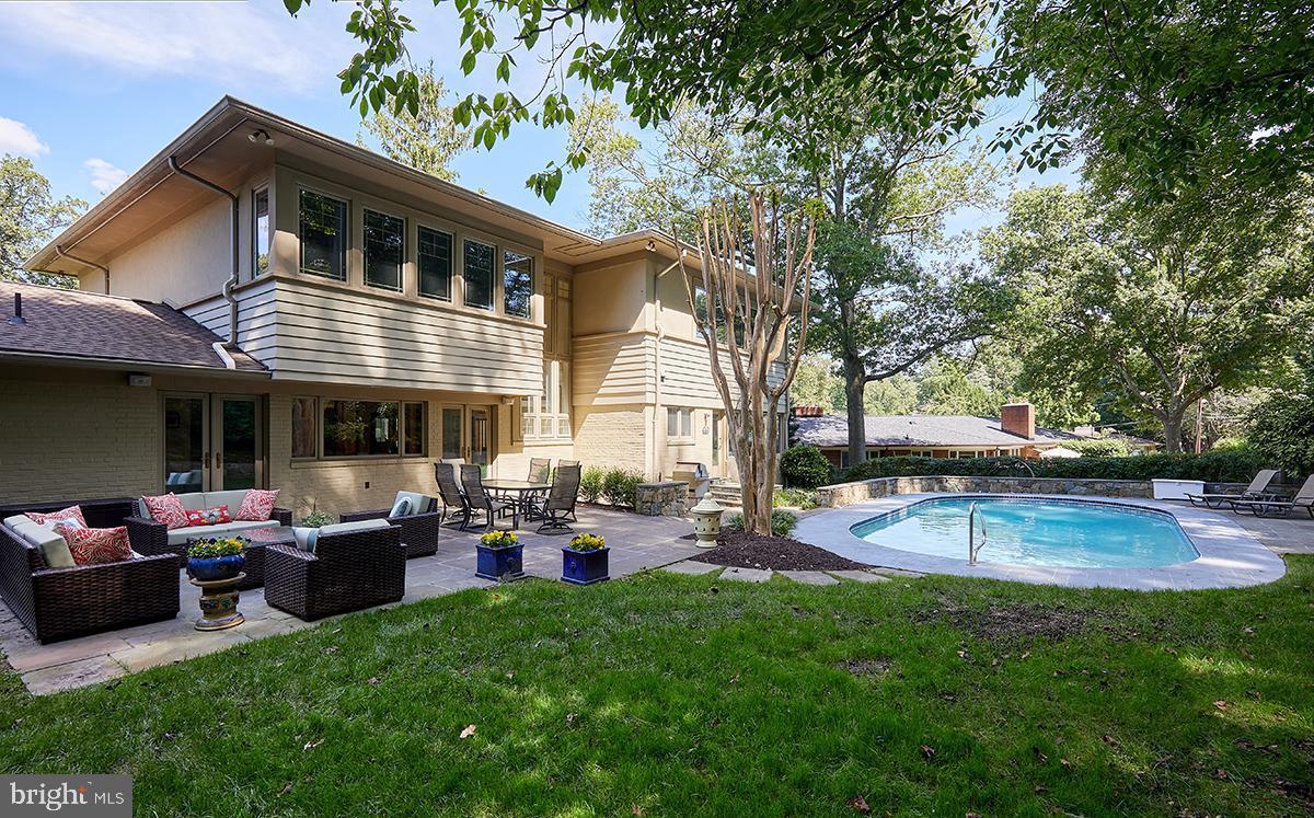 Luxury abounds in this striking Mid-century modern beauty with third-floor addition, 1/3 acre lot and heated swimming pool in Tulip Hill.
Updated and renovated over the years by the current owners, this fabulous 6400 sq ft home features expansive rooms, 6 bedrooms, 6.5 baths, home office(s) and delightful outdoor living areas.
The main level boasts two bedrooms with en suite baths, formal living and dining rooms, kitchen, powder room, cozy family room, sun room and access to the private rear patio, pool and terraced yard.
The second level features a laundry room, 3 generous bedrooms with en suite bathrooms, including a huge primary suite with two walk-in closets and a sitting area.
Lower level rec room, bedroom, bathroom, workshop, gym, wine storage and second laundry room.
Fabulous outdoor spaces include a flagstone patio with lounging and dining areas, pool, grill area and a tiered additional lawn above the backyard. Landscape lighting and sprinkler system throughout.
Tulip Hill is an amazing community of broad boulevards, neighborhood dog walks, and Front-Yard-Fridays. Quick commute to Downtown DC, Bethesda, Tysons Corner and National and Dulles airports. Woodacres/Pyle/Whitman.