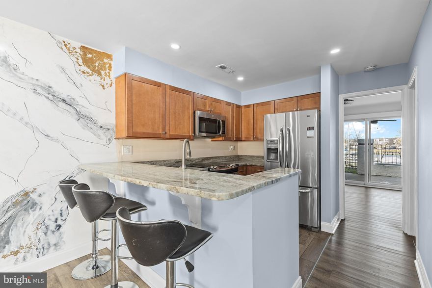 Price Improvement!! Marina-front and perfectly sized for easy living or a weekend escape.

This one-bedroom one-bath condo offers approximately 724 square feet with an open floor plan and a geourgous view. Walk into a bright living area that flows seemlessly into the adjacent kitchen, creating an inviting and functional space for everyday living or entertaining.

The kitchen has been updated with granite countertops, stainless steel appliances, upgraded cabinetry with self-closing drawers, and a clean, modern layout that maximizes both storage and workspace. Luxury vinyl plank flooring was added throughout, giving the home a cohesive and low-maintenance finish. The living room also features handmade, unique Venetian Stucco wall art straight from Italy that adds character and warmth to the space.

The bedroom is located on the marina side and opens directly to a private, partially covered patio with full marina views, making it the ideal spot to enjoy morning coffee or unwind at sunset. The sunsets here are among the best in the community. Two outdoor storage closets are located off the patio, a rare and valuable feature for a one-bedroom unit.

Lower condo fees help keep monthly expenses manageable, making this an excellent option for a primary residence, second home, or weekend getaway. For added peace of mind, the seller is offering a one-year home warranty to the buyer.The building roof was replaced in 2020 with 30-year architectural shingles.

Queens Landing is known for its Spanish-style architecture and resort-style amenities, including a waterfront heated pool, fitness center, tennis and pickleball courts, clubhouse, and walking paths along the Chester River and marina. Boat slips are available for rent or purchase, and residents enjoy the convenience of being able to walk to nearby restaurants.

A rarely available marina front one bedroom offering water views, outdoor space, and affordability in one of Kent Island’s most established waterfront communities.