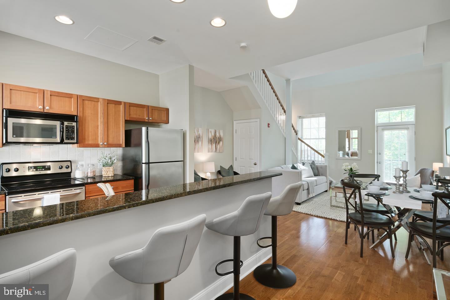 Extraordinary opportunity at the coveted Naval Square: Stunning top floor, bi-level one bedroom, one bath condominium residence located within the historic, boutique Biddle Hall. Enter into the modern kitchen, outfitted with stainless GE appliances, natural maple shaker-style cabinetry and black absolute granite breakfast bar and countertops. The open floorplan on the main level has gleaming oak hardwood floors, a spacious living/dining area, and additional space for an office/desk. Just off the living area leads you onto your large private terrace (with retractable screen door) overlooking lush park grounds; perfect for entertaining. The sunny master bedroom features a large master closet with custom built-ins, vaulted ceilings and clerestory windows with motorized shades, allowing for exceptional natural light with just a touch of a button. The master bath features a double sink vanity with granite counters, more custom built-in shelving, a large stall shower and separate deep soaking tub perfect for relaxing after a long day. The stackable, full-size washer/dryer is conveniently located in the master bath. Large coat/storage closet on main level & separate storage locker included in building. Park in your DEEDED PARKING SPACE (P-93) or walk just steps over the South St. Bridge to UPenn, Drexel, CHOP & HUP. Prime location for faculty, staff, and Med Residents affiliated with the hospitals and Universities. All this with extraordinary Naval Square amenities: concierge, state-of-the-art fitness center, seasonal pool, dramatic community room in Biddle Hall (also available for private functions), gated community with 24-hour security. Enjoy the outdoor amenities of the 20-acre park-like setting: including picnic areas, well-kept gardens & mature Sycamore trees. Exciting restaurants, shops, cafes & nightlife located just outside the gates in the Graduate Hospital Area, Fitler and Rittenhouse Squares. Only steps out the back gate you can enjoy the Schuylkill River Park, including the Award Winning Trail and nearby dog park! Low utilities and condo fees make ownership incredibly affordable. This unit is a must see!