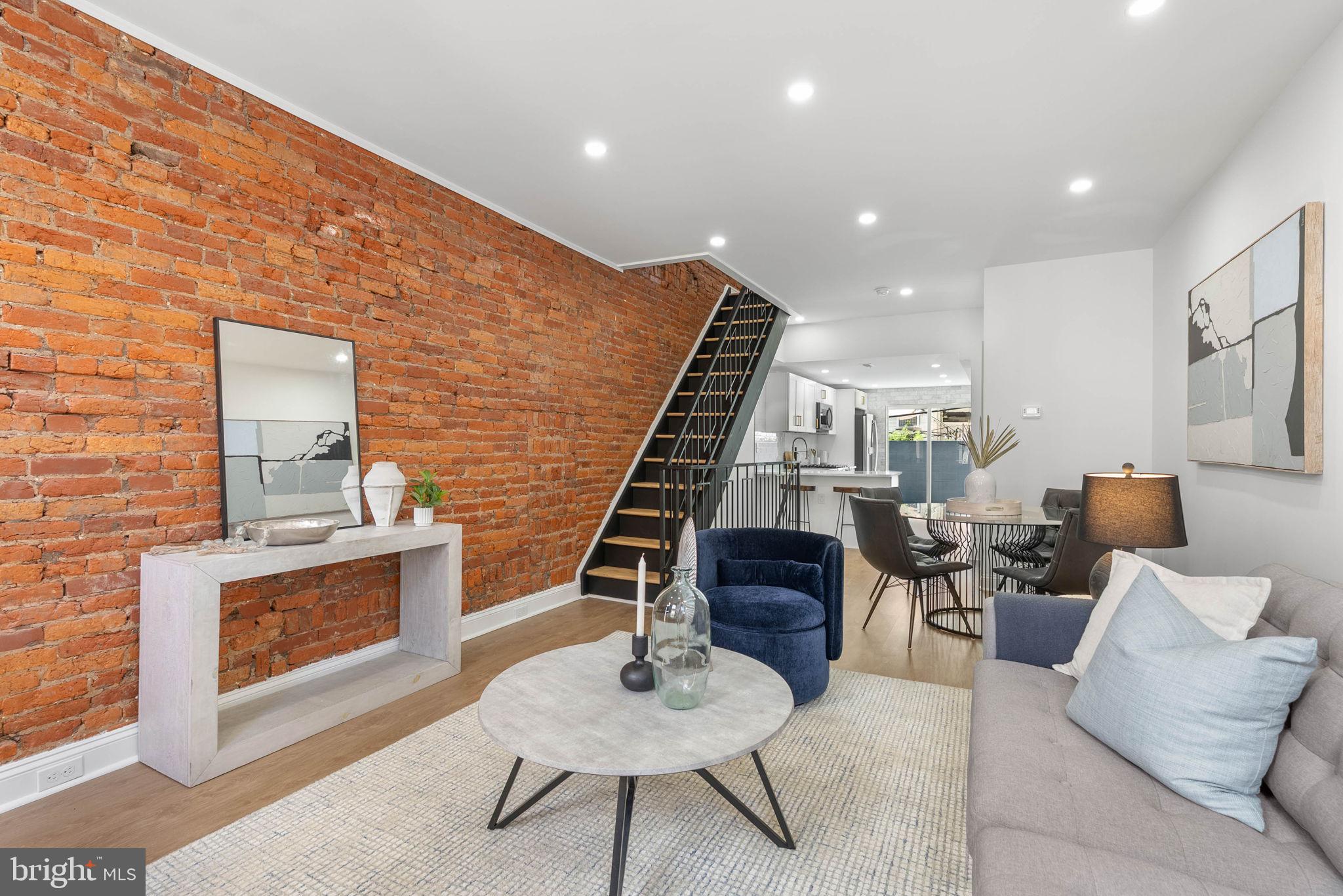 Welcome to your dream home in Melrose in South Philly! This fully renovated 2-bedroom, 1.5-bath beauty with a finished basement has been transformed from top to bottom, blending modern design with timeless charm. Step inside to discover wide-open living and dining areas highlighted by a dramatic exposed brick wall and new vinyl flooring throughout. The chef’s kitchen is a showstopper, complete with bar seating, brand-new stainless steel appliances, white shaker cabinets, glass subway tile backsplash, under-cabinet lighting, and ample prep space. A sliding glass door fills the room with natural light and opens directly to your private backyard oasis, the perfect canvas for gardening, barbecues, and entertaining. A chic new half bath with designer tile completes the first floor. Downstairs, the finished basement offers generous ceiling height with endless possibilities such as a home office, gym, playroom, or media room. Upstairs, you’ll find two bedrooms, including a spacious primary bedroom with two large closets, plus a full bath featuring a sleek tiled shower, bespoke vanity, and modern finishes. Every detail has been thoughtfully updated with all new systems including the roof, HVAC, plumbing, electrical, and hot water heater for total peace of mind. Enjoy the convenience of Holy Cannoli Café at the top of the block, and just a few minutes walk to some of South Philly’s favorite spots like Tap Room on 19th, Heavy Metal Sausage, Stina, Café y Chocolate, and Café Nhan. The location can’t be beat with easy access to I-95 and 676, public transportation, and the stadium district just steps away. This stunner checks every box. Schedule your showing today!