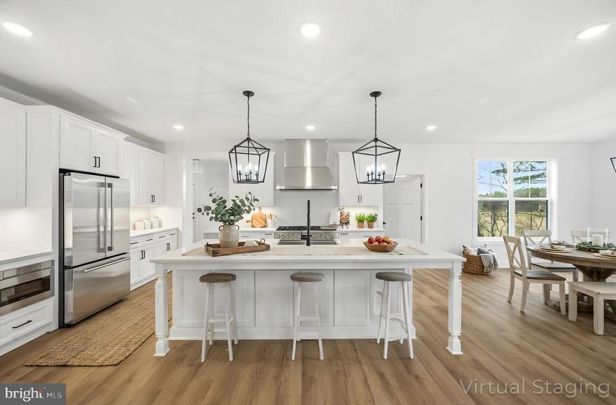 Exceedingly rare, brand-new custom Craftsman on 6.72 private acres in the picturesque Rivers Edge community in Lovettsville is available now. This exceptional residence offers nearly 5,000 finished square feet on three levels and a highly sought-after main-level primary suite—a combination rarely found in Loudoun County.

A welcoming slate front porch sets the tone, offering the perfect spot to relax and take in the peaceful, open views of the surrounding landscape. The home’s exterior showcases timeless craftsmanship with Hardie plank siding, black exterior window sashes and a striking four-sided stone water table on both the home and garage, adding durability, texture, and upscale curb appeal. Thoughtful architectural details complete the classic Farmhouse look, creating a warm and impressive first impression.

An inviting two-story foyer filled with natural light showcases custom trim, high ceilings and refined workmanship throughout. The open-concept layout is ideal for today’s lifestyle, anchored by a chef’s kitchen featuring quartz countertops and backsplash, soft close cabinetry, under mount cabinet lighting, farmhouse sink, walk-in pantry and a luxury appliance package, including a 48” six-burner gas range with a griddle and double ovens. The kitchen flows seamlessly into the morning room and expansive two-story family room with a 4' extension and gas fireplace, perfect for entertaining or everyday living. Make your way from the morning room onto the covered rear porch for your morning coffee or evening wind down.

The main-level primary retreat offers privacy and comfort with a large double sided walk-in closet and a spa-inspired bath complete with freestanding soaking tub, dual vanities, and a 7’ x 6’ marble walk-in shower with dual shower heads and benches. Additional main-level spaces include a formal dining room with amazing views, a very private office with French doors and plenty of sunlight and an expansive multi-use mudroom where the powder room, laundry room, large storage closet and drop zone are located.

Upstairs, you’ll find three generously sized bedrooms and two full baths. The finished walk-out lower level has 9' ceilings and expands the home’s versatility with a large recreation room, a legal bedroom, full bath and abundant storage—perfect for guests, multigenerational living, or a home gym. Plenty of room to expand if needed.

This home is richly appointed with luxury plank flooring, ceramic tile, black hardware and fixtures, open railings, wood staircases, ceiling fans in all bedrooms and an impressive 8-foot farmhouse front door. The breezeway connects the mud room to the 3-car garage, offering 800 square feet of space and is pre-wired for EV charging. 

Enjoy the best of Loudoun County living—privacy, space, and craftsmanship—while remaining just minutes to restaurants, shopping, and commuter routes. Close to the Potomac River, MARC Train, wineries, breweries, organic farms, town parades, the Lovettsville Community Center and watch movies in the summertime at the Walker Pavilion. At Lovettsville Community Park you can enjoy many different sports fields, an equestrian ring with trails, a nature trail, off leash area for dogs and a pond for fishing. A rare opportunity for new-construction luxury on acreage in Northern Virginia. Call for an appointment today and start living the Loudoun County lifestyle.