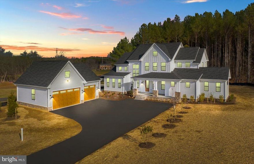 Exceedingly rare, brand-new custom Craftsman on 6.72 private acres in the picturesque Rivers Edge community in Lovettsville is available now. This exceptional residence offers nearly 5,000 finished square feet on three levels and a highly sought-after main-level primary suite—a combination rarely found in Loudoun County.

A welcoming slate front porch sets the tone, offering the perfect spot to relax and take in the peaceful, open views of the surrounding landscape. The home’s exterior showcases timeless craftsmanship with Hardie plank siding, black exterior window sashes and a striking four-sided stone water table on both the home and garage, adding durability, texture, and upscale curb appeal. Thoughtful architectural details complete the classic Farmhouse look, creating a warm and impressive first impression.

An inviting two-story foyer filled with natural light showcases custom trim, high ceilings and refined workmanship throughout. The open-concept layout is ideal for today’s lifestyle, anchored by a chef’s kitchen featuring quartz countertops and backsplash, soft close cabinetry, under mount cabinet lighting, farmhouse sink, walk-in pantry and a luxury appliance package, including a 48” six-burner gas range with a griddle and double ovens. The kitchen flows seamlessly into the morning room and expansive two-story family room with a 4' extension and gas fireplace, perfect for entertaining or everyday living. Make your way from the morning room onto the covered rear porch for your morning coffee or evening wind down.

The main-level primary retreat offers privacy and comfort with a large double sided walk-in closet and a spa-inspired bath complete with freestanding soaking tub, dual vanities, and a 7’ x 6’ marble walk-in shower with dual shower heads and benches. Additional main-level spaces include a formal dining room with amazing views, a very private office with French doors and plenty of sunlight and an expansive multi-use mudroom where the powder room, laundry room, large storage closet and drop zone are located.

Upstairs, you’ll find three generously sized bedrooms and two full baths. The finished walk-out lower level has 9' ceilings and expands the home’s versatility with a large recreation room, a legal bedroom, full bath and abundant storage—perfect for guests, multigenerational living, or a home gym. Plenty of room to expand if needed.

This home is richly appointed with luxury plank flooring, ceramic tile, black hardware and fixtures, open railings, wood staircases, ceiling fans in all bedrooms and an impressive 8-foot farmhouse front door. The breezeway connects the mud room to the 3-car garage, offering 800 square feet of space and is pre-wired for EV charging. 

Enjoy the best of Loudoun County living—privacy, space, and craftsmanship—while remaining just minutes to restaurants, shopping, and commuter routes. Close to the Potomac River, MARC Train, wineries, breweries, organic farms, town parades, the Lovettsville Community Center and watch movies in the summertime at the Walker Pavilion. At Lovettsville Community Park you can enjoy many different sports fields, an equestrian ring with trails, a nature trail, off leash area for dogs and a pond for fishing. A rare opportunity for new-construction luxury on acreage in Northern Virginia. Call for an appointment today and start living the Loudoun County lifestyle.