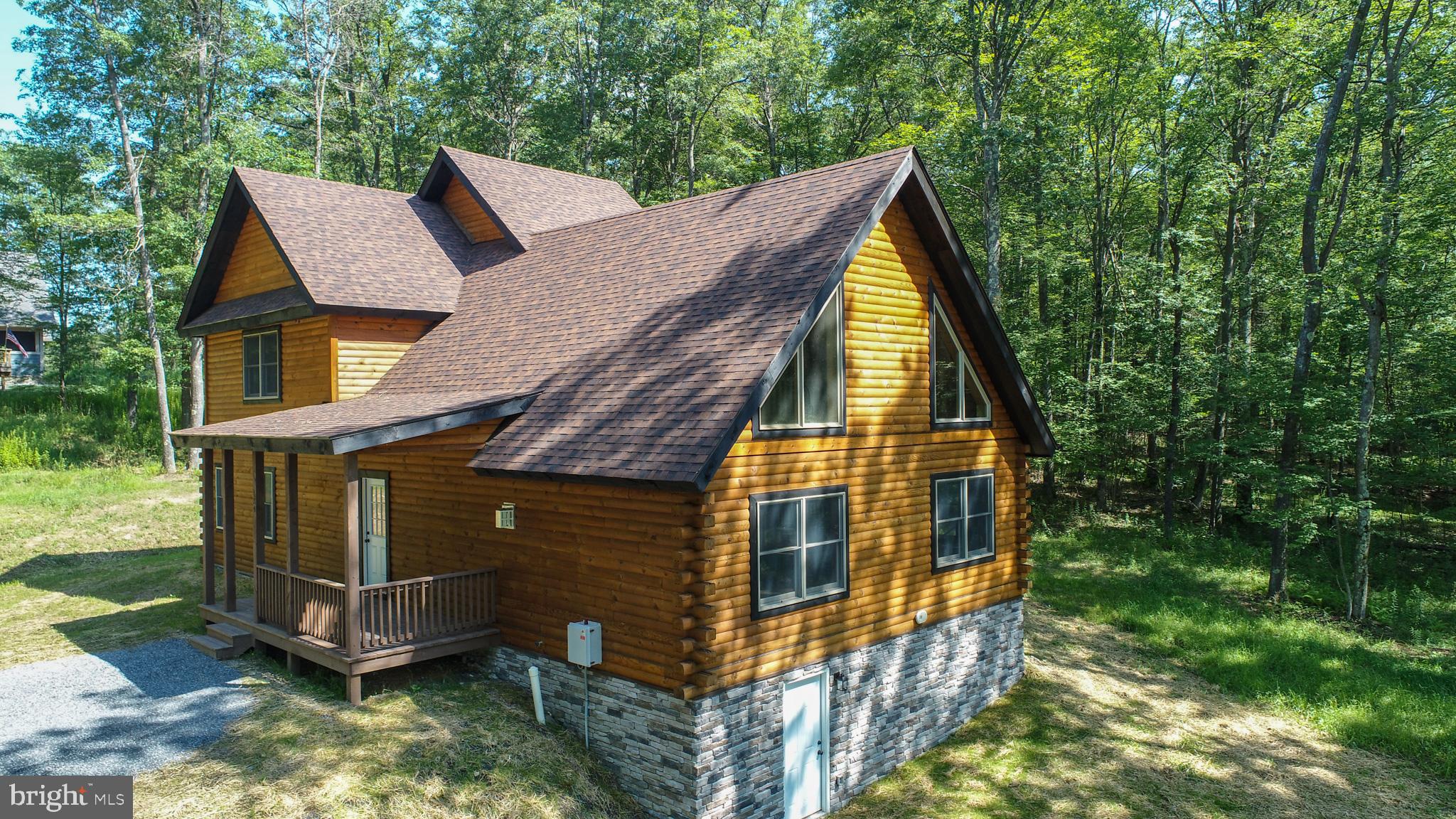New Construction recently finished by Lost Land Construction, is located in Deep Creek Estates community. This Mountaineer Custom Log Home is Crafted with attention to detail and featuring high-quality custom finishes throughout. Home features the perfect blend of mountain charm and modern comfort.
Highlights include: Pine Log wood walls, ceilings, and LVT flooring for a timeless rustic look.
Custom kitchen with access to a covered back porch—ideal for outdoor dining and relaxation
Main-level laundry room for everyday convenience. Custom tiled shower in upper level bathroom.
Full basement ready for future finishing or extra storage. Located just minutes from Deep Creek Lake and Wisp Ski Resort, this thoughtfully designed home is ready for you to make it your own.
Call today to schedule your private showing!