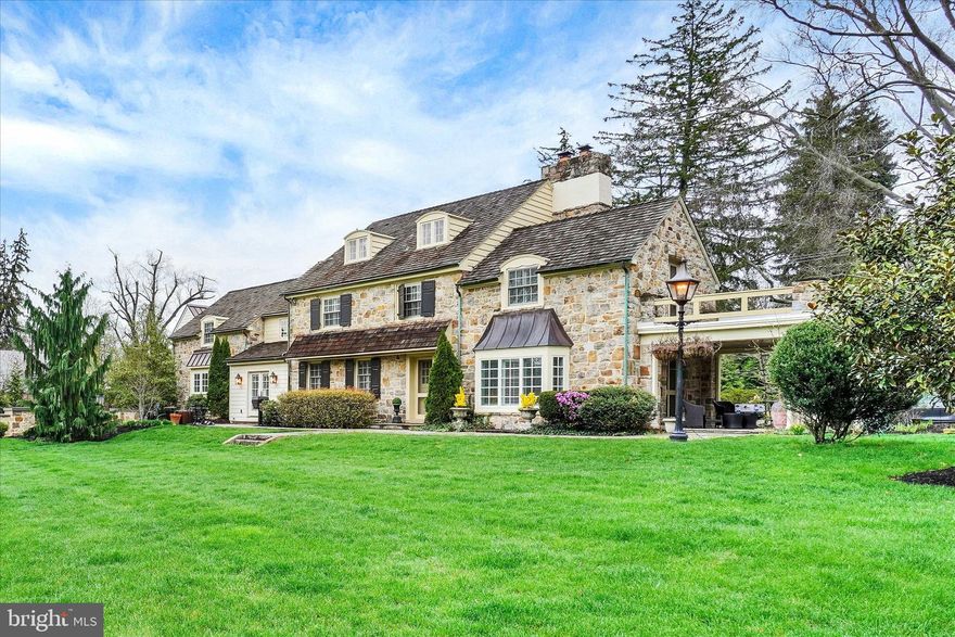 A rare offering in prestigious Wyndham Hills, a timeless treasure. Located in York Suburban School District—this extraordinary historic stone estate has been masterfully reimagined to deliver an unparalleled blend of heritage, and modern luxury. Thoughtfully revived and expanded, every detail reflects superior craftsmanship, refined design. At the heart of the home, the expanded gourmet kitchen is both striking and functional, featuring Simeral custom cabinetry, an impressive 7-foot island, soapstone countertops, Monogram Series appliances, pot filler, 6 burner gas range, a farm-style kitchen sink, and a full-size refrigerator and freezer. Generous wall length pantry cabinets increases the beauty and practicality. Rich wood flooring flows seamlessly throughout, complemented by a well-appointed laundry room with tile flooring, folding space, and additional storage.
Designed for both intimate living and grand entertaining, the home offers a formal dining room just off the kitchen, while a sunlit sitting area with patio doors creates a serene space for morning coffee overlooking the outdoor setting. A gracious living room with gas fireplace, a private first-floor office with custom built-ins and pocket doors, and both a formal spiral staircase and secondary rear staircase add architectural elegance and everyday convenience.
The primary wing is a true private retreat, complete with balcony access, an expanded walk-in closet, and a spa-inspired bath featuring a travertine tiled shower with stone shower floor and elegant dual vanity—offering both beauty and a natural, refined finish. In total, the home offers 5 bedrooms, 4 full baths, and 2 half baths, two of them are ensuites with their own private bath, providing exceptional comfort and privacy for family and guests.
The finished lower level showcases the home’s historic charm with exposed stone walls and a statement fireplace, complemented by a wet bar and billiard room—an ideal setting for entertaining.
Outdoors, a resort-inspired setting awaits with a heated in-ground pool (2021), dramatic stone accent wall, and outdoor fireplace—creating a private and inviting space for relaxation and gatherings.
Additional exceptional features include a 3-car garage with ensuite living space above, a dedicated gym, expansive mudroom, walk-up attic with built-ins for storage or future living space, upgraded electric, 2-zone heating and cooling (2021), all new windows, enhanced millwork with double crown molding, and an artistic metal roof.
This remarkable residence is more than a home—it is a statement of lifestyle, where historic character meets modern luxury in a setting designed for both refined living and unforgettable entertaining.