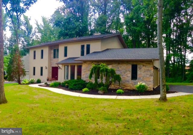 Totally remodeled contemporary on a wooded lot near a stream.  Attached 3 car garage.  All new custom kitchen cabinets, granite counter tops, hardwood floors and carpeting.  Vaulted LR ceiling. LR fireplace.  Large decks across the back of house.  Basement is dry and open with roughed in plumbing for a bathroom.  Great location, immaculate home, excellent schools