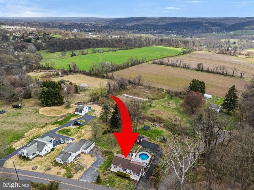 Pictures coming Wednesday! 
Perched high above the valley in sought-after South Coventry Township, this cute-as-a-button ranch feels like something out of a storybook - only with views that are very real and very hard to leave behind. Set on over half an acre, you’re treated to sweeping Chester County hills, protected farmland, and sunsets that feel a little extra magical. People say the best views come after the hardest climb… but here, it’s just a few steps out your back door.

Step inside through a bright, welcoming breezeway with tiled floors (featuring marble accents and inlays), a ceiling fan, and sliders that immediately hint at the outdoor oasis waiting beyond. The living room is equal parts cozy and character-filled, with bamboo hardwood floors, recessed lighting, classic wainscoting, and intricate woodwork framing a fireplace with electric insert and granite hearth - basically begging for slow evenings and good company.

The dining room keeps the charm going with hardwood floors and soft arched entryways, leading you into an updated kitchen that blends personality and function with granite countertops, a tin backsplash, stainless sink with gooseneck faucet, and replacement windows perfectly placed to capture that incredible backyard view (yes, even doing dishes feels a little better here).

The main level offers two cozy bedrooms with hardwood floors and an updated hall bath with tiled walls and tub surround - simple, comfortable, and just right. Downstairs, the walk-out lower level adds flexibility with a large finished space (currently used as the primary bedroom) complete with a step-in closet and a dramatic full bath featuring a walk-in shower with sitting bench and rain showerhead. It’s not just beautiful - it’s practical too, especially after a day spent poolside. Laundry and storage round out the lower level.

And then… you step outside - and this is where things get really fun. A multi-level outdoor setup creates your own private retreat, featuring an above-ground saltwater pool with lighting features, wraparound decking, a brand new Trex upper deck with updated railing, and a sprawling lower-level concrete patio. Float in the pool (new liner 2023), look out over the valley, and watch butterflies drift through an ever-changing landscape of perennials - banana trees, clematis, butterfly bushes, and more. A tiered koi pond adds a little extra magic, because of course it does. Raised bed gardens offer the perfect spot to grow your own flowers, herbs, and veggies… mini farm stand anyone?

For the outdoor enthusiast, Woody’s Woods trail access sits right across the street with over 250 acres for hiking and mountain biking adventures. And when it’s time to head back to reality, you’re just 2 miles from the schools and minutes to Route 422 and the PA Turnpike - making this peaceful escape surprisingly convenient.

Whimsical, welcoming, and quietly unforgettable - this is the kind of home that feels like a getaway you never have to leave.