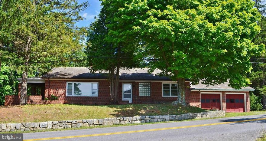 ALL BRICK RANCHER-- Four bedroom brick rancher on one acre with large wrap porch, separate screened porch, two car attached garage shaded by majestic trees just minutes from down town Berkeley Springs, WV.