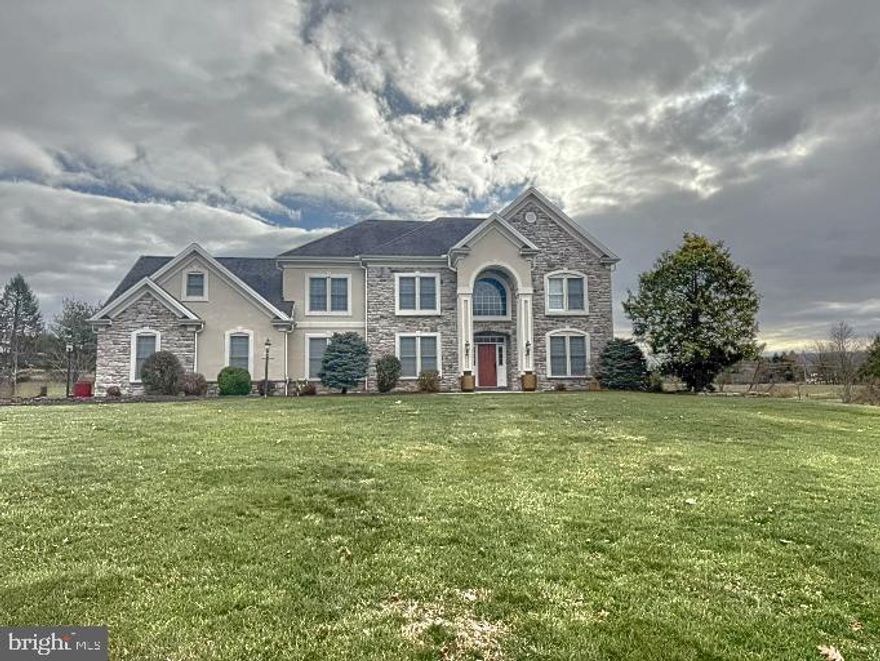 This spacious, two-story single-family home is situated on 3.5 acres in Southridge development in Fairview Township, York County, within West Shore School District. With 6 bedrooms, 4 full baths, and 1 half bath, this home offers ample space for comfortable living.
Upon entering, you'll be greeted by an open foyer leading to a well-appointed first floor. This includes a bedroom with an en-suite full bath and a private deck. The kitchen is fully equipped with granite countertops, a gas cooktop, wall oven, double stainless steel sink, and ceramic tile floors. It seamlessly flows into the eating area and living room, which boasts a cozy propane fireplace. The main floor also features an office, formal dining room with a butler's pantry, and a sunny Florida room with access to the rear deck. The laundry and mudroom offer direct access to the 3-car garage.
Upstairs, the primary bedroom is a true retreat with a spacious walk-in closet, sitting area with propane fireplace, and an en-suite master bath complete with a jetted tub, steam shower, and double vanity. Three additional bedrooms and a full bath with double vanity complete the second floor.
The finished walk-out lower level features an in-law/au pair suite with its own propane fireplace, providing both privacy and convenience. The home is equipped with modern utilities including private sewer and well, electric heat pump, and an electric water heater.
The large, level lot features a variety of fruit trees, a spacious garden area with berry bushes, and a newly installed electric fence, perfect for outdoor enjoyment and privacy.
This home is located in a peaceful, family-friendly neighborhood, offering a wonderful balance of privacy and convenience, with easy access to nearby amenities and Red Land High School.