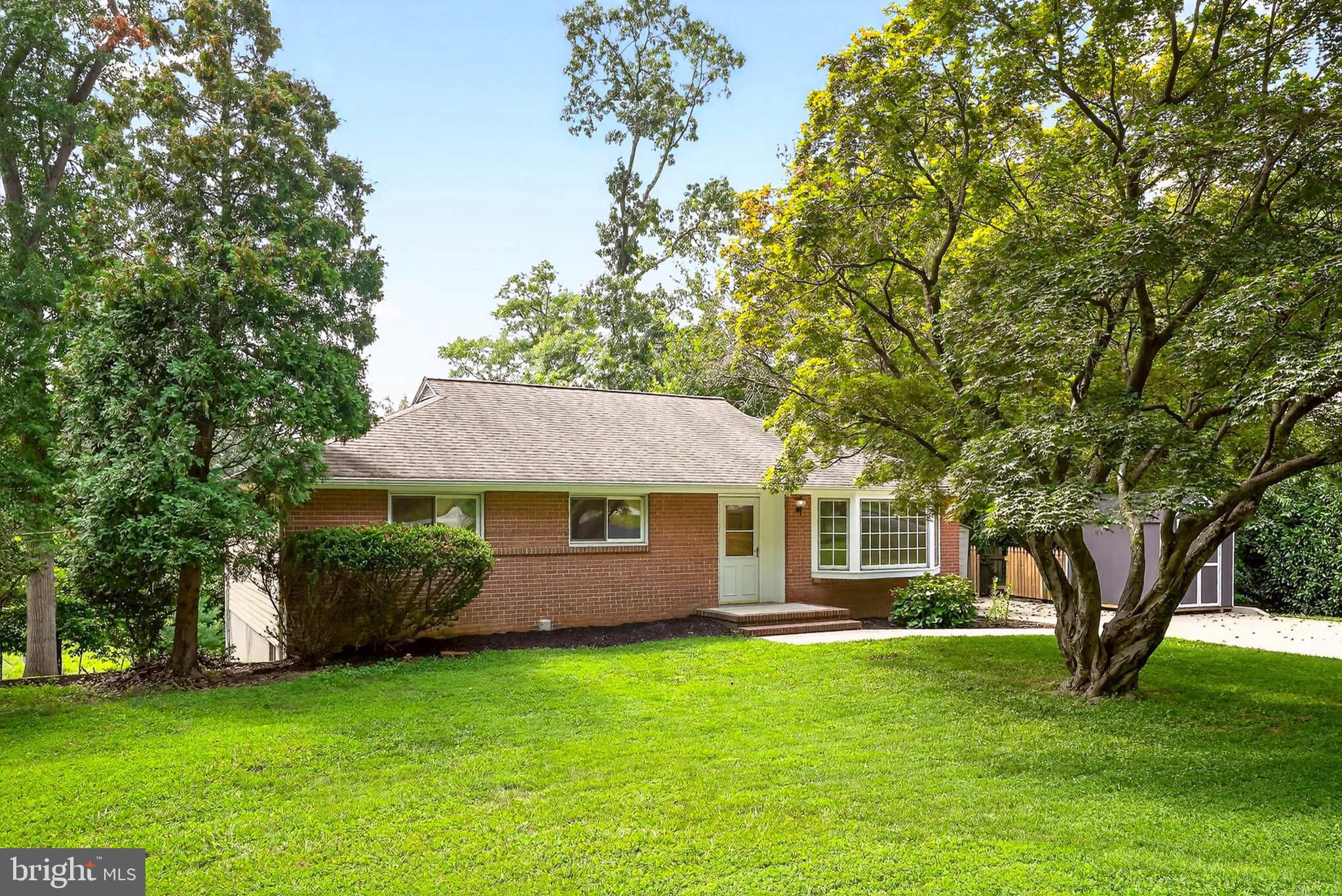 Come home to this charming brick rancher situated on a spacious, private half-acre lot. This property offers a peaceful setting with tree-lined views and plenty of outdoor space. Inside, the home features 1,892 square feet of finished living area, including four bedrooms, with an additional bedroom or office in the lower level, and 2.5 bathrooms. The interior has been thoughtfully updated, including a modernized kitchen completed in 2021 and brand-new carpeting in the lower level.
The main level showcases pristine hardwood floors throughout, an expansive living room with a bay window, a dining room, the updated kitchen, a primary bedroom with an attached half bath, two additional bedrooms, and a full hall bathroom. The finished lower level offers new carpet, a sprawling living space, a bedroom, an additional bedroom or office, a full bath, a laundry room, and walkout access to the backyard.
Additional features include a freshly top-coated private driveway and a secure storage shed. The backyard is a serene retreat, perfect for relaxing or entertaining. Overall, this home blends classic charm with modern updates in a desirable Ellicott City location, known for its excellent schools, quiet residential atmosphere, and proximity to shopping, dining, and major commuter routes. Don’t miss the opportunity to own this beautifully maintained home...schedule your showing today!