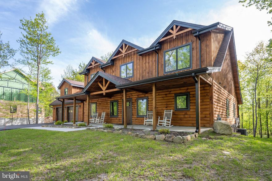 Extravagant Log Lodge located on The Lodestone Golf Course - Completed in Fall of 2023, This luxurious 5Bedroom 5.5Bath situated on over half an acre of wooded land, and directly adjoining Hole 6 Tee Boxes of the prestigious Lodestone Golf Course, just minutes to local establishments, Wisp Resort & Deep Creek Lake! Encapsulated in rustic, oversized 8" logs, this home features vaulted ceilings, hardwood oak floors, detached two car garage with bonus room above, gourmet chefs kitchen with hidden pantry, granite tops and elegant finishes throughout. Main level Primary Suite walks out to the back deck overlooking the golf course, with fully tiled bathroom, standing tub and spa shower. Two more suites on the second story, split by a spacious loft overlooking the the great room with additional office. Lower level living area offers a sprawling recreation room equipped with a full service wet bar and 2nd gas fireplace. 4th ensuite, built in bunk room and 5th bath complete the finished basement. 2 Zone HVAC system and heated floors on the lower level are sure to keep you comfortable all year round. Sold fully furnished and sparing no expense, this log home is sure to impress anyone looking for a rustic mountain getaway, that satisfies every modern comfort. Seller offering incentives for better buyer financing terms. Ask for details... Call today for your private showing!