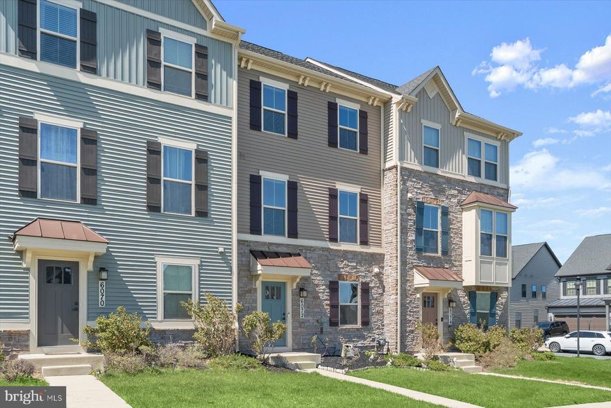 Welcome to 6072 Fallfish Court, a stunning four-level townhome located in the desirable Oakdale Village at Lake Linganore, offering five bedrooms and four and a half baths with beautifully designed living spaces throughout. The entry level welcomes you with two convenient coat closets, a private bedroom, full bath, and interior access to the garage ideal for guests, a home office, or multigenerational living.
Upstairs, the main living level features an expansive and light-filled layout with a bright dining area and family space centered around a gorgeous kitchen appointed with luxury vinyl plank flooring, quartz countertops, a center island with breakfast bar, stainless steel appliances, pantry, and a charming coffee station. The dining area opens directly to an oversized Trex balcony, perfect for outdoor dining or relaxing. This level also includes a spacious living room with plush carpeting and a convenient powder room.
The upper level is highlighted by the serene primary suite featuring an en-suite bath with dual vanities, a soaking tub, and a glass-enclosed shower. Two additional bedrooms, a full hall bath, and a laundry area complete this level. The top floor offers incredible flexibility with an expansive fifth bedroom or entertainment room, complete with a full bath and access to a huge rooftop deck, an exceptional space for entertaining or enjoying the views.
Life at Lake Linganore brings resort-style amenities right to your doorstep, including private beaches, pools, clubhouses, boat ramps, piers, paddle sports, tennis and volleyball courts, disc golf, tot lots, summer concerts, farmers markets, and miles of scenic trails. All of this is just minutes from the shopping, dining, and entertainment of Frederick and Urbana, with easy access to I-70, MD-75, and Route 40 for an effortless.