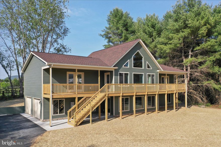 Brand new construction mountain retreat chalet, currently under roof, offering the perfect blend of year-round living and weekend getaway appeal—with short-term rental potential and breathtaking mountain views. Tucked away at the end of a quiet cul-de-sac with no thru traffic, this home delivers privacy, peace, and scenery in every direction.
The thoughtfully designed split-bedroom floor plan features a stunning primary en suite complete with a freestanding soaking tub, tile shower, walk-in closet, and private covered front porch—your own personal spot to relax and soak in the views.
At the heart of the home, the great room impresses with vaulted ceilings, expansive windows flooding the space with natural light, and direct access to the covered front porch, perfectly framing the mountain backdrop. The kitchen shines with quartz countertops, a 6-foot island for additional seating, painted cabinetry, and an adjacent dining area—ideal for entertaining or cozy nights in.
Luxury vinyl plank flooring runs throughout the main living areas, with tile in the guest bath. The main-level laundry adds everyday convenience. The oversized 2-car garage (25 x 22) comes equipped with an opener and remote.
The main level offers 1,804 finished square feet, while the lower level provides an additional 1,254 square feet with abundant windows for natural light—ready to be finished to suit your needs and already roughed in for a third full bath.
Additional highlights include a paved driveway, vinyl siding, low-E windows, and quality construction throughout. Whether you’re seeking a serene mountain home, a weekend escape, or an income-producing retreat, this property checks all the boxes.
✨ Mountain views, modern comfort, and endless potential—this is the one.

 Shenandoah Farms offers several common areas, including playgrounds, basketball courts, and lakes, for residents to use! River Lot Access** – Enjoy fishing, kayaking, and scenic views **Two Lakes** – Perfect for outdoor adventures **Playground & Tot Lot** Don’t miss the opportunity to own this beautifully designed home in a peaceful location! The property is located off a paved road, while Riley is a gravel road. PREFERRED LENDER  PAY 1% OF THE LOAN AMOUNT FOR BUYERS' CLOSING COSTS. Short-term rentals are allowed in this area. Please check with county guidelines. 
PHOTOS are similar - see documents for features and finishes