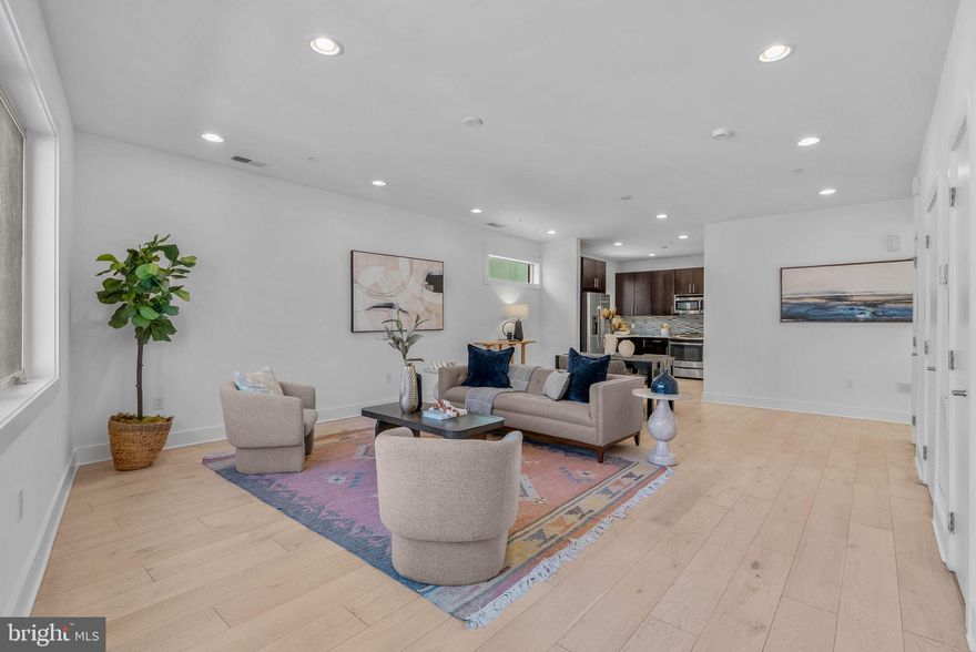 Welcome to this stunning 3 bedroom, 2.5 bath home in highly sought-after Queen Village, complete with a roof deck and assigned parking space. Thoughtfully designed with an exceptional floor plan, every space in this home feels both functional and refined, enhanced by high-end finishes throughout. The main living areas feature beautiful hardwood floors, soaring ceilings, and recessed lighting, creating a bright and airy atmosphere. The designer kitchen is a true centerpiece, outfitted with quartz countertops, premium stainless steel appliances, sleek cabinetry, and stylish fixtures. Upstairs, the spacious primary suite serves as a private retreat, boasting a generous sleeping area, walk-in closets, and a luxurious en-suite bath with double wall-hung vanities, glass-enclosed shower, and striking tile work. Two additional bedrooms are well-proportioned and offer excellent closet space. Additional highlights include a separate laundry room with a full-size washer and dryer, as well as multiple outdoor spaces, including the show-stopping roof deck. Square footage & real estate taxes should be verified by the buyer independently.