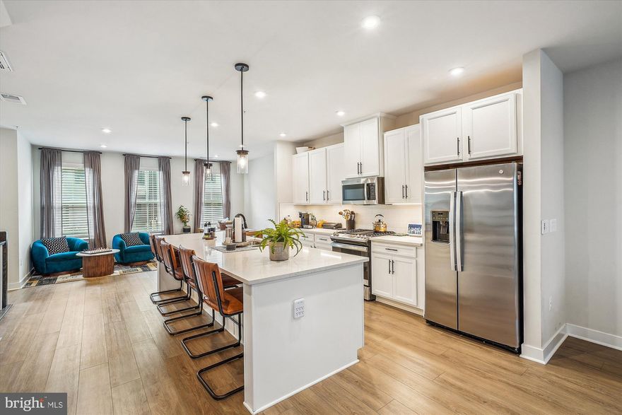 Stunning Condo-Style Townhome in Sought-After Potomac Shores! This beautifully designed home features luxury vinyl plank flooring throughout the main level and a spacious open-concept layout. The gourmet kitchen boasts stainless steel appliances, a large center island with bar seating, and stylish pendant lighting. Enjoy meals in the separate dining area and relax in the expansive family room, complete with a ceiling fan and access to a luxurious covered balcony—featuring its own ceiling fan and cozy fireplace, perfect for year-round enjoyment. Upstairs, you'll find three generously sized bedrooms. The primary suite offers a tray ceiling, walk-in closet, and a spa-like en-suite bathroom with a tiled shower and private water closet. Two additional bedrooms share a full hallway bath. Additional features include a 1-car garage equipped with an EV charging outlet. Included in the rent: washer and dryer, Wi-Fi, trash service, and lawn maintenance. Enjoy resort-style amenities just steps away, including a golf course, two pools, and playgrounds all within walking distance. Situated in a prime location, this property is just minutes from I-95, Quantico, and an array of shopping and dining options. The community amenities are second to none. Residents of Potomac Shores enjoy exclusive access to a 13,000-square-foot indoor/outdoor playground, a Social Barn for gatherings, a Fitness Barn with a modern gym, movement studio, and yoga lawn, as well as a family pool with a sundeck, cabanas, kids’ pool, and snack bar. Outdoor enthusiasts will appreciate the 5+ miles of trails for running, biking, or walking, as well as opportunities to launch a kayak, join social clubs, or play a round of golf at the Potomac Shores Golf Club – the only publicly accessible Jack Nicklaus Signature Design course in Northern Virginia. With convenient commuting options to Quantico, Ft. Belvoir, and the Pentagon, this home offers an unbeatable combination of luxury, convenience, and community. Don’t miss the rare opportunity to own a one-of-a-kind custom smart home in the vibrant Potomac Shores community!