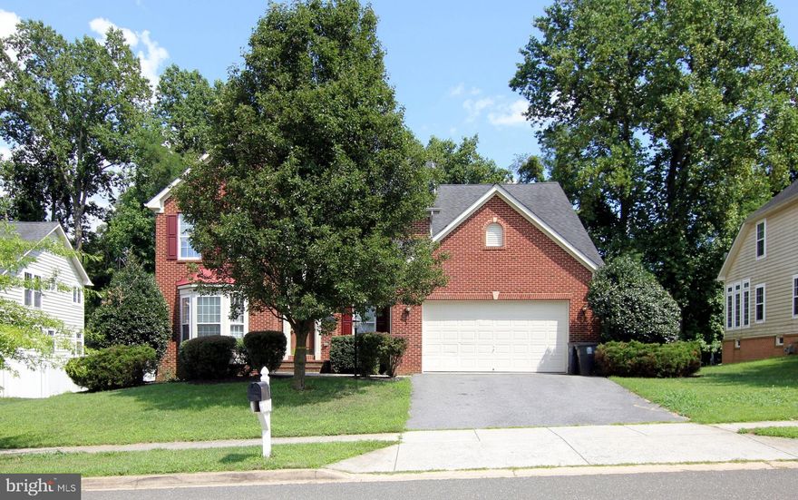 This is not Barbie's dream home, but it might just be yours. Brick-front colonial with two car garage and not a drop of pink in sight. New carpeting and neutral paint throughout. The dramatic two-story foyer is flanked on one side by a formal living room and dining room on the other. The kitchen is complete with an island, stainless steel appliances, granite counter tops and is definitely the heart of the home, bright and airy with the light from the adjoining sunroom and open to the family room with fireplace so the cook can always be part of the action. The lower level is fully finished and includes a den or spare bedroom, full bath and a back room that is just made to be a media room. The four bedrooms upstairs include the spacious primary bedroom with walk-in closet and bath with separate shower and soaking tub. Don't wait for the weekend to see this.