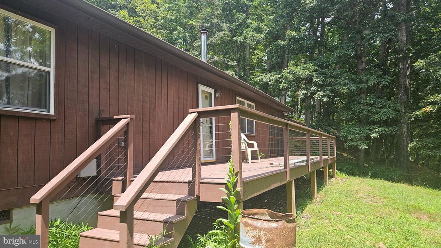 Two bedroon cabin in a gated community along the Cacapon River with a picnic grove and place to leave your canoe, kayak, john boat.  This wooded 5.60 acre lot offers seclusion and mountain views to the southwest.
Home is being sold "as is, where is", the seller is not emptying the very cluttered cabin or doing any repairs of upgrades.  There is much to be done to make the house livable.