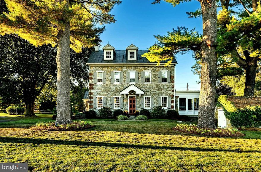 Discover the enchanting beauty of Blue Pig Farm, a magnificent Pennsylvania farmhouse set on a picturesque 10 acres of pristine land enriched with natural charm and a large, tranquil pond. This impressive limestone home, steeped in history, dates back to the early 1800s and boasts a grand total of 4,166 interior upper level  sq ft. The lower level is a clean, unfinished space with fireplace for an additional 1,299 Sq ft!  This property is designated as "Clean and Green" for lower taxes.
This historic residence features five spacious bedrooms and three full baths, along with one half bath on main level . You'll be captivated by the meticulous restoration undertaken by local craftsmen and interior designers, seamlessly blending historic charm with modern luxury.
The chef's kitchen is truly awe-inspiring, featuring custom cabinetry, an oversized island with casual seating, and a stunning fireplace that creates a warm and inviting atmosphere. The home's random width floors enhance the character, allowing the kitchen to flow effortlessly into a large dining room enveloped in windows, offering breathtaking views of the pond.
Adjacent to the dining room is a beautifully designed heated sunroom with a flagstone floor, perfect for entertaining year-round. Step outside to discover a charming stone walkway leading to a lovely flagstone patio, complete with a cedar pergola and a stone fireplace/grill, ideal for outdoor gatherings.
Inside, the expansive living room—affectionately referred to by the owners as the “lounge”—provides the perfect setting for entertaining friends before dinner, featuring two intimate seating areas and a cozy fireplace. Just off this space, a library/office with its own fireplace offers a peaceful retreat and access to the enclosed porch.
The rear of the main floor hosts a charming private in-law suite that includes a gorgeous bedroom with a covered porch, a beautifully remodeled bath, and a stunning great room with vaulted ceilings and a kitchen. Currently used as a primary suite, this versatile space can serve many purposes, featuring direct access to the main house as well as its own private entrance!
The upper level unveils the primary bedroom suite, showcasing a lavish walk-in shower and bath, a spacious sitting room, and three additional bedrooms serviced by a third exquisite bath. The expansive unfinished basement boasts a wood-burning fireplace, offering endless possibilities for customization.
Blue Pig Farm is equipped with updated mechanical systems,  RO water system, central air conditioning and public water and sewer services. Situated in the coveted Green Valley area, this remarkable home offers a unique opportunity to experience the tranquility and beauty of farmhouse living while enjoying modern luxury amenities and convenience.  The estate is only 7 miles from Blue Marsh Lake , and is within walking distance to the Wilson SD Middle School as well as the Green Valley C.C. !