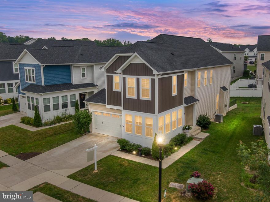 Luxurious Winchester Home in the Heart of the highly sought after Two Rivers Community! This amazing home boasts over 4,400 square feet of beautifully finished living space with 9' ceilings throughout all 3 levels. Step inside this stunning and highly sophisticated home and you will immediately see the attention to detail this home exudes. A bright and airy front living room, adorned with two walls of expansive windows that invite natural light to flood the space. The seamless rear open-plan design connects the gourmet kitchen to the family room and dining area, creating a welcoming atmosphere for all of your gatherings. The elegant kitchen features a spacious island, pristine white cabinets, sleek countertops, a stylish backsplash, and high-end stainless steel appliances, including a wall oven and built-in microwave.  Pendant lighting adds a touch of sophistication. The first floor also features a versatile bedroom currently utilized as a home office, along with a half bathroom. Entry from the two-car garage includes a functional, built-in bench, coat rack, and shelving. Head on up to the second floor, where the primary suite awaits, complete with a modern tray ceiling, two generous walk-in closets and a spa-like bathroom featuring a deep soaking tub, a separate shower, two sinks, and a linen closet. Two additional bedrooms share a third full bathroom, and the second bedroom boasts its own en-suite and walk-in closet. The walk-out finished basement casts an inviting ambiance and highlights a large rec room, an additional bedroom, and the 4th full bathroom. Brand new slider off the main level leads out to rear patio. Large utility and storage room provide the additional space to keep your household belongings organized and clutter-free. Experience the vibrant lifestyle that the Two Rivers community has to offer, complete with amenities that enhance your daily living; Outdoor Pool, Club House, Fitness Center, Common Grounds, Dog Park, Jogging Trail, Coummunity Lake, Tennis Courts, Playground, Volleyball & Basketball Courts. Open to all ages. Schedule your showing before it's too late!