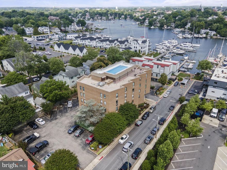 Experience the exceptional in this stunning home located in the highly desirable Newport Condominium community in Eastport. This is the one you’ve been waiting for, where thoughtful design details and updates have all been done for you, so all you have to do is move right in. The open-concept layout of the home provides a convenient and spacious living area. One of the highlights is the private balcony, which offers some water views of Spa Creek, allowing you to relax and take in the beautiful surroundings. The interior of the home is filled with natural light, creating a bright & inviting atmosphere. Gorgeous galley-style kitchen features subway tile backsplash, quartz countertops, Shaker-style soft-close draws and cabinetry, and stainless-steel appliances. Owner’s retreat features a stylish pocket door with bath and dual closets just beyond. Make your guests comfortable in the home’s hidden Murphy bed offering maximum convenience. Newport is ideally situated at the end of a cul de sac with an adjoining waterfront pocket park. Newport residents enjoy access to a private pier and dock for kayaks and paddleboards, with boat slips available for an additional fee.  The rooftop pool deck offers a terrace for seating and dining with spectacular views of the Capital Dome, the USNA Dome and Saint Mary’s steeple. Convenient parking is available in the adjoining private lot; guests are welcome to park on the street without a permit. Building includes keyed entry and call system for added security and peace of mind. Nearby you’ll find multiple yacht clubs, and an easy pedestrian thoroughfare to historic Downtown Annapolis. This location offers a wonderful blend of waterfront living, outdoor recreational opportunities, and proximity to the vibrant lifestyle of living in Annapolis.