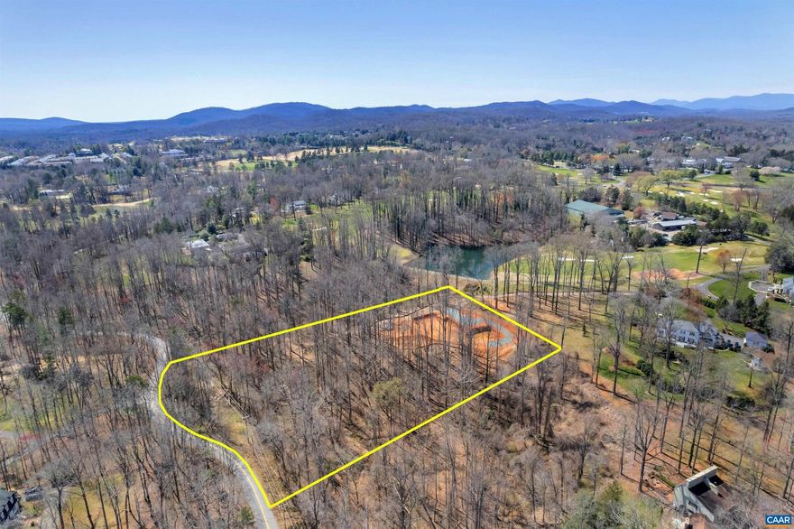 This is perhaps the final opportunity to build on an unimproved parcel in Farmington. The 3.7-acre lot overlooks the 12th fairway, a pond, and a forest of mature hardwoods. It is extremely private, located at the end of quiet Old Mill Road. Long thought to be inaccessible, the current owners went to great lengths to ensure the viability of this lot. For the first time, this property can now be accessed from inside Farmington. A nearly 6,000-square foot house with a six-car garage has been approved by Farmington's ARB, and the foundation for that home has been dug. That footprint can be used, or the purchaser can start anew. Plans and soil reports can be shared with interested, qualified parties. This is arguably Albemarle County's most valuable available building site. Create a remarkable estate in a remarkable community.