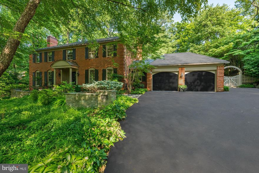 Classic elegance meets updated comfort in the Cedars of McLean. Tucked away atop a private drive in the sought-after Cedars of McLean community, 1091 Old Cedar Road sits proudly on a beautifully landscaped 0.63-acre lot, offering exceptional privacy, curb appeal, and serene indoor-outdoor living. Surrounded on three sides by wooded common area, this special lot offers a unique location within the community due to its adjacency to Old Cedar Court cul-de-sac which provides for extra parking and a walkway to the front and basement entrances as well as to the fenced back yard.  For walkers, runners or canine parents, the property enjoys close proximity to Bull Neck Stream Valley Park and its extensive trail network. 

This meticulously maintained brick colonial features 4 bedrooms, 4 full baths, and 1 half bath, and spans approximately 4,530 square feet of refined living space across three finished levels with additional unfinished space ready for customization. Thoughtfully updated and rich in character, the home blends classic architecture with tasteful enhancements—including light oak flooring, Farrow & Ball wall covering, and designer lighting throughout. 

Inside, the main level is anchored by a sun-drenched family room featuring a dramatic floor-to-ceiling fieldstone fireplace, beamed ceiling, custom built-ins, and French doors that open to the rear terrace and patio. Adjacent lies the French country-inspired kitchen, offering custom cabinetry, upgraded appliances, and a cozy breakfast table area with garden views. Additional main-level highlights include formal living and dining rooms, a warm and inviting library with built-in shelving, and a recently renovated mudroom and laundry area with a door leading to the back garden.

The back of the home features multiple doors leading to the fully fenced rear garden which features mature landscaping, a large play yard, elegant hardscaping, a curved flagstone terrace, and a charming gazebo and garden shed—perfect for outdoor entertaining or quiet reflection.

Upstairs, the primary suite serves as a spacious retreat with an expansive sitting area (or future closet), walk-in closet, and a beautifully renovated bath with dual vanities, soaking tub, and walk-in shower—complete with premium finishes. Three additional bedrooms and 2 full baths are generously sized and filled with natural light, all with hardwood floors and custom design elements.

The walk-out lower level offers incredible versatility and features a large recreation room with a 3rd fireplace and direct access to a side terrace, a wetbar, and a full bath. The absolutely massive storage room is ideal for organization or of course future expansion (perhaps in-law suite) of finished living space.

Situated in one of McLean’s most desirable neighborhoods and within the Langley High School pyramid, this home effortlessly combines charm, function, and thoughtful updates—making it a rare and timeless offering.