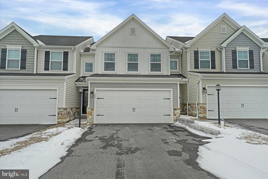Welcome to this like-new townhome in the desirable Harvest Meadows neighborhood, ideally located less than four miles from Beaver Stadium and Penn State University. Designed for easy living, this home is perfect as a primary residence, weekend retreat, or Penn State getaway property. The main living level features an open and inviting layout with abundant natural light, a spacious living area, a convenient half bath, and a well-appointed kitchen with modern finishes, ample cabinetry, and an island ideal for everyday living or entertaining. The adjacent dining area flows seamlessly to the outdoor space, creating a comfortable setting for both relaxing and hosting guests. Upstairs, the primary suite offers a private retreat with a walk-in closet and en suite bath. Two additional bedrooms and a full bathroom provide flexibility for guests, home office space, or additional living needs. Convenient second floor laundry adds everyday ease and functionality. The finished walkout lower level adds valuable living space with a full bathroom, making it ideal for a second living area, guest space, or home office setup. With three bedrooms, three and a half bathrooms, and thoughtful design throughout, this move-in ready townhome offers comfort, convenience, and proximity to everything State College has to offer.