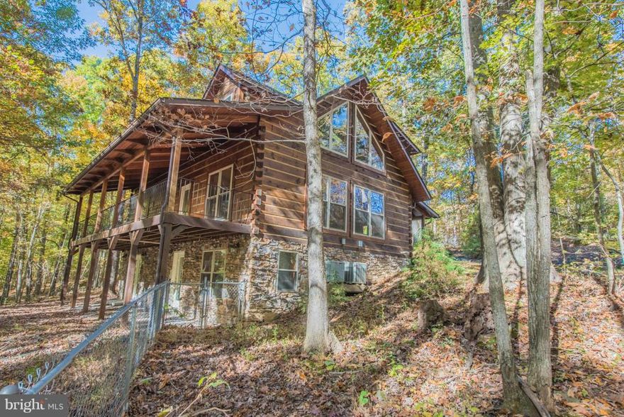 NO HOA!  Fantastic Log Home on 13+ Acres just minutes from Skyline Drive & downtown Front Royal, Va!  Vaulted great room w/ stone fireplace, exposed beams, and doors to front & rear covered porches.  1st floor master bedroom suite w/ whirlpool bath, upper level sleeping loft + 2 additional bedrooms.  Full basement w/ finished family room, full bath & flue for wood stove.  Additional acreage.