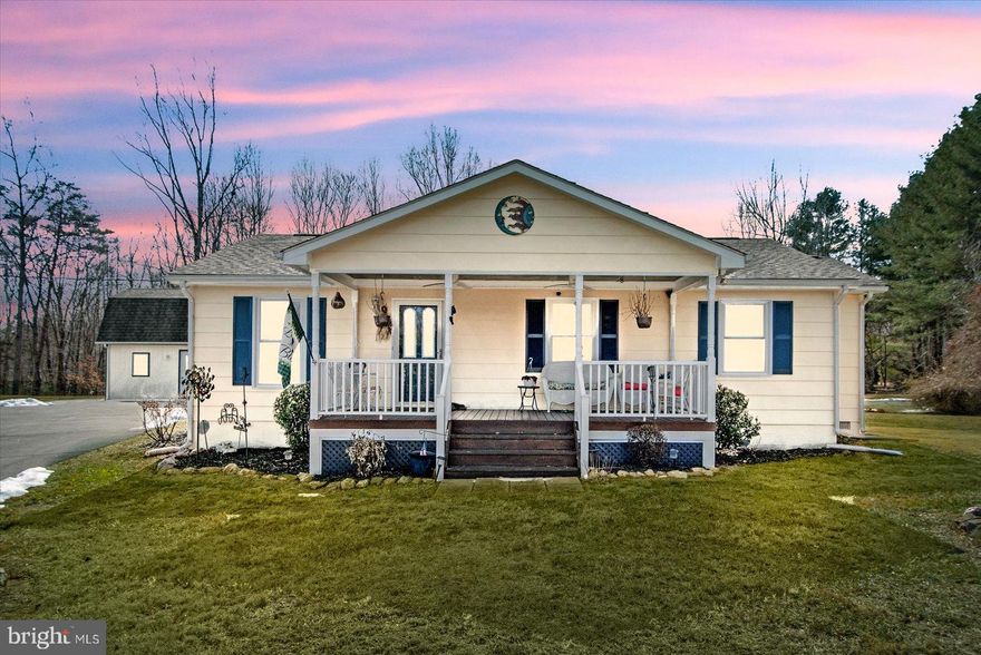 Experience the perfect blend of charm and luxury in this meticulously maintained ranch-style home. Situated on an expansive corner lot in a picturesque setting, the property welcomes you with an inviting front porch cooled by ceiling fans. Inside, gleaming hardwood floors lead to a sprawling living room centered by a cozy gas fireplace with a classic stone surround. The heart of the home is the recently remodeled eat-in kitchen, featuring a stunning hammered-copper apron-front sink, custom backsplash, granite countertops, and abundant cabinetry. The primary bedroom serves as a sanctuary, boasting a beautiful tray ceiling, stylish custom barn doors, and a generous walk-in closet. You can also relax in the recently renovated spa-like bathroom, anchored by an extra-large walk-in shower with modern finishes. A rare highlight of this property is the two-story insulated building equipped with heating, cooling, and electricity. Formerly a woodshop, it offers limitless potential for a home office, creative studio, or an income-producing separate dwelling. A metal shed is available for extra storage. Outdoor living is equally impressive on the large patio, complete with a pergola for entertaining. With a newer roof, encapsulated crawl space, HVAC, windows, and tankless water heater, this move-in-ready gem is as functional as it is beautiful.