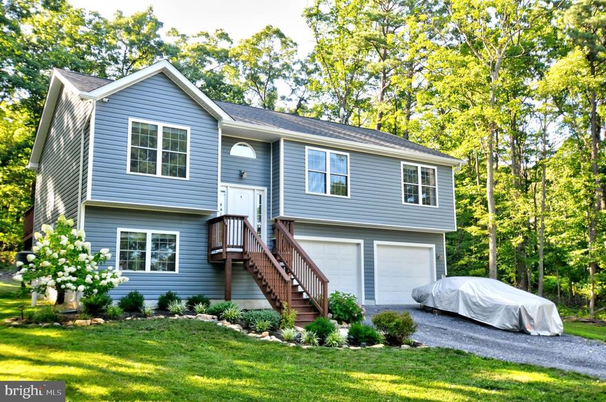 Beautiful 3 bed, 2.5 bath split foyer on a gorgeous .52-acre lot backing to mature trees. Enjoy outdoor living on the paver patio with built-in firepit, surrounded by thoughtful landscaping that enhances curb appeal and privacy. Spacious interior layout, bright natural light, and a peaceful setting make this home an ideal blend of comfort and convenience. Enjoy granite countertops, table space, stainless steel appliances, electric cooking, and a center island with breakfast seating in the kitchen. Luxury vinyl plank flooring throughout.  Let this one impress from the moment you arrive.