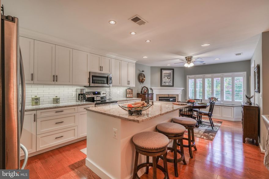 Welcome Home! Absolutely stunning  2 bedroom 2 full bath condo in highly desirable and rarely available Roundwood Ridge II Condominiums! Meticulously maintained and barely lived in- Sellers only lived in property 3 months out of the year! Bright sun filled rooms with fresh neutral paint and custom plantation shutters throughout. Gleaming manufactured wood floors. Beautiful gourmet kitchen features large island with quartz counters and fresh white custom shaker cabinets, newer stainless steel appliances, subway tile back splash and breakfast room/ dining area with gas fireplace, built in bench, and access to balcony.  Spacious primary bedroom has walk-in closet and full bath with double vanity, large shower with brass frame and ceramic tile floors. Both bedrooms with newer carpet. Separate laundry room w/full size brand new washer and dryer. Unit comes with a storage on 6th floor*  Ample outdoor parking. Conveniently located minutes to shopping, restaurants, I83 and I695. This one won't last!