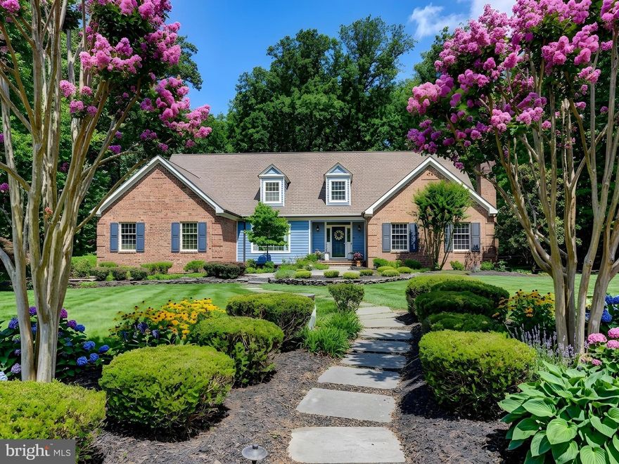 Springhill Farm Court is possibly the most coveted street along the always in demand Falls Road Corridor in Hunt Valley.  Convenient yet private.  Peaceful yet accessible.  46 Springhill Farm Court offers all of these features plus many more.  The rear yard connects directly to Oregon Ridge Park providing easy access to hundreds of miles of trails, not to mention privacy.  The first floor Primary suite adds another level of convenience and includes a gorgeous spa like bathroom that was completely renovated in 2025.  The kitchen was renovated in 2021 and features high end appliances, two islands and two sinks, for ease of living.  A recently renovated laundry room includes a perfect dog bath.  The sunroom is tucked away behind the kitchen and offers days long views of the rear yard and the park beyond.  On the second level of the home you will find four spacious bedrooms and two full bathrooms.  If you need more living space the basement is mostly finished and provides endless options and flexibility.  There is a three car garage with EV charger, epoxy floor, and additional storage.  Enjoy outdoor living space on the expansive deck and brand new patio in the rear.  This is a true 5 bedroom home with approximately 6800 square feet of living space on a cul-de-sac.  It is light and bright and has a great flow, and it is truly not to be missed.