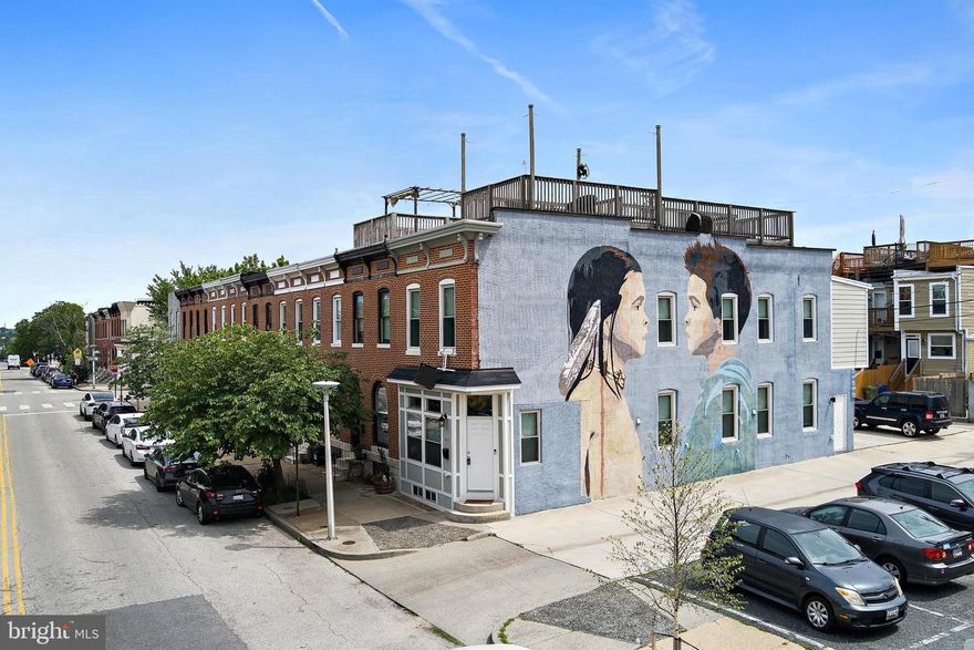 Welcome to 419 S East Avenue, an exquisitely renovated end-of-group townhome nestled in the heart of Highlandtown/Canton with 3-Car Parking Pad! This 15 feet wide, 3-bedroom, 3.5-bathroom residence spans over 2,200 square feet, offering a seamless blend of historic charm and contemporary elegance. Enter the home to find gleaming hardwood floors, coffered ceilings, and exposed brick. The gourmet kitchen is a culinary dream, boasting sparkling granite countertops, sleek stainless steel appliances, white cabinetry, beverage fridge and an oversized island perfect for entertaining. The upstairs offers two large bedrooms and two full bathrooms. Enjoy panoramic city views from the rooftop deck, accessible via an interior staircase. Additional highlights include a finished basement, in-unit laundry, and third bedroom and full bath, giving you ample living space. Located just steps from Patterson Park, local eateries, and cultural hotspots, this home offers the perfect blend of comfort and convenience.