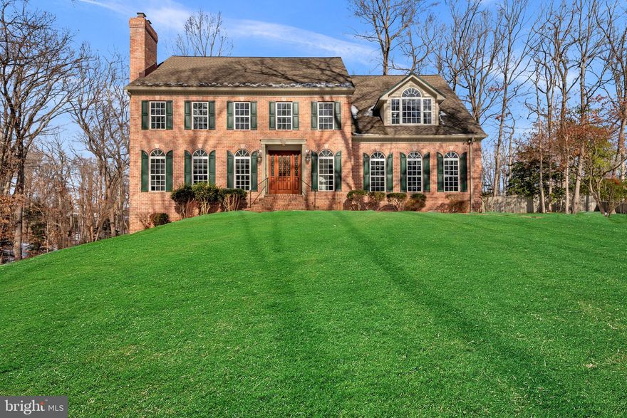 Welcome to this stunning, move-in-ready custom-built colonial brick home, perfectly situated on over an acre of picturesque land. With meticulous attention to detail, this home combines comfort, style, and functionality in a peaceful, private setting.

Upon entry, you are greeted by a spacious foyer and a convenient half bathroom. To your left, the large living room offers a cozy wood-burning fireplace, ideal for relaxing on cool evenings. Adjacent to the living room, the elegant dining room boasts beautiful hardwood floors and an abundance of natural light, creating an inviting space for family gatherings and dinner parties.

The heart of the home lies just down the hall in the expansive kitchen. Featuring recessed lighting and undercounter lighting, this kitchen offers ample space with a large center island, perfect for meal preparation or casual dining. The charming breakfast area/sunroom, complete with skylight windows, brings the outdoors in and is the perfect spot for morning coffee. Off the kitchen, the impressive family room features soaring cathedral ceilings, more skylights, and a gas fireplace, making it an ideal space for relaxation. French doors open to the outdoor deck, extending your living space to the beautifully landscaped yard.

Upstairs, the massive owner’s suite is a true retreat, offering a private sitting room, a large walk-in closet, and an En-Suite bathroom. This spa-like bathroom is designed with luxury in mind, featuring a double vanity with quartz countertops, a walk-in shower, a soaking tub, and a separate water closet. Down the hall, two generously sized bedrooms are perfect for family or guests, with one currently set up as an office. The last bedroom upstairs impresses with tall ceilings, recessed lighting, a spacious closet, and an upper loft area for extra versatility. The second story also includes another full bathroom, a cedar closet for additional storage, and a convenient laundry room with a laundry sink.

The fully finished basement offers a large area perfect for entertaining, complete with a built-in bar and sliding doors that open to the outdoors. A fifth bedroom and a full bathroom with a tub and shower complete the lower level, offering extra privacy for guests or family members.

For car enthusiasts or anyone in need of ample storage, the 3-car garage is a standout feature with 14-foot ceilings and a slop sink.

This home is ready for you to move right in and offers close proximity to major commuting routes, making it the perfect place to call home.