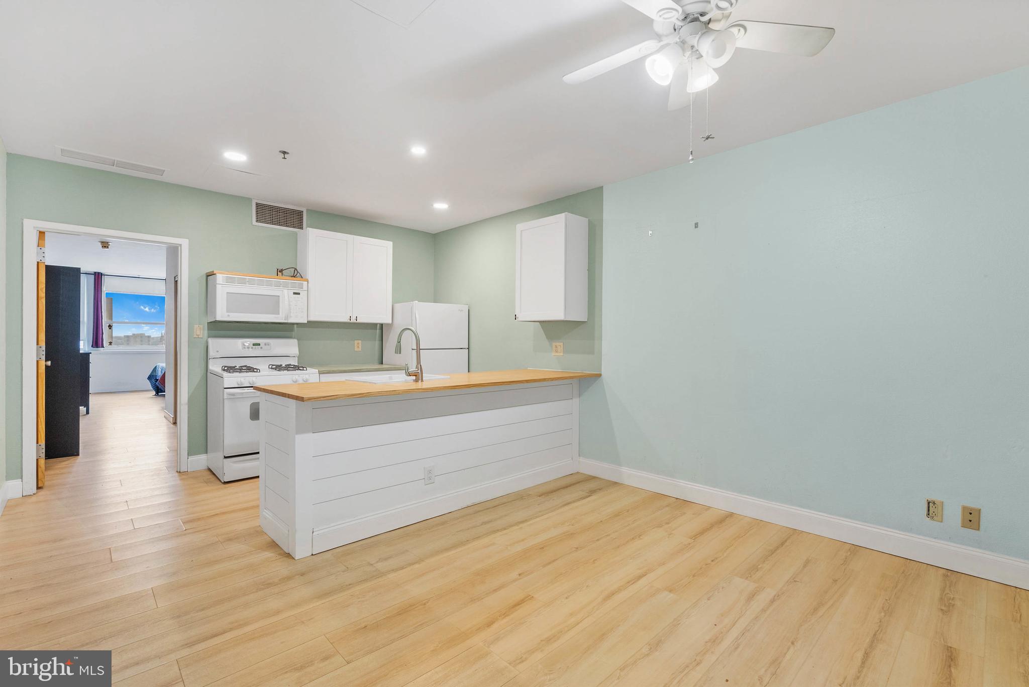 Unit #1403 at The Grand View Condominiums is an updated 1-bedroom, 1-bath condo with central a/c, located in the heart of Philadelphia's vibrant Chinatown neighborhood. This pristinely maintained elevator building offers a welcome desk staffed, a gym, on-site laundry, a peaceful garden, a dog run, and a community lounge. Entering the unit, you'll find a spacious living room with hardwood floors and a ceiling fan, while the open kitchen has white cabinetry, a full suite of appliances, including a dishwasher, butcher block counters, and breakfast bar seating. The large bedroom suite boasts massive windows with skyline views, a double closet, and a full bathroom with an extra-wide vanity. There is a good size storage unit in the basement that is included. One of the building's best features is its prime location, which earns a near-perfect Walk Score of 99! Popular restaurants, friendly shops, and diverse markets are all steps away, along with Reading Terminal, the Fashion District, the Philadelphia Convention Center, and City Hall. Sprawling Franklin Square Park hosts community events nearby, plus Jefferson and Pennsylvania Hospitals are close. There's also easy access to public transit, I-676, I-76, I-95, and South Jersey. Schedule your tour today!