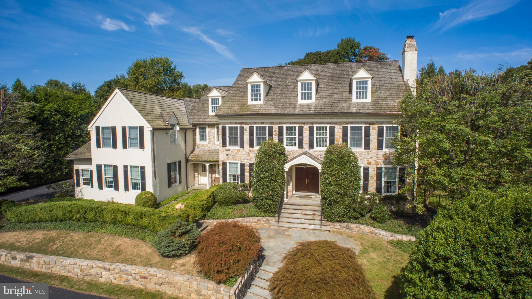 Welcome home to this stately 5/6 bedroom stone colonial manor home in the sought-after Harrison Estate community. You will know you have arrived to your new elegant lifestyle as you enter the circular drive and are welcomed by an airy two story foyer with marble floors and wainscoting. The straight-through foyer gives a sight line through the french doors to the slate patio, outdoor kitchen with pergola, & level playing field. To the right of the foyer is an arched doorway to the formal living room with grand, cultured marble gas fireplace and rich hardwood floors. The study/office is just through the french doors and features cherry paneling and built-in cabinetry. Escape to read a book in the sunroom, surrounded on three sides by windows and glass doors to the patio. To the left of the entrance hall is the large formal dining room with wainscoting and extra wide crown moulding. A butler s pantry with beverage fridge leads you to the gourmet kitchen with white Kountry Kraft cabinets, a 6 burner & griddle Jenn Air range, built-in Sub Zero refrigerator and oversized island. The kitchen boasts a sunny breakfast room with walk-in pantry and sliding doors to the slate patio. Adjacent to the kitchen is the huge family room with vaulted ceiling, built-in cabinetry with speaker system and a gas fireplace, huge windows, overlooking the yard. Main and back staircases, 2 half baths, a mudroom and 3 car garage complete this level. The second floor features a his & hers closets lead you to the luxurious master bath with dual vanities, jetted tub and large shower with rain shower head and body sprays. There are 2 additional en-suite bedrooms and 2 bedrooms that share a jack and jill bath. Convenient second floor laundry and a homework/computer station. The third floor is a great finished bonus space with two large closets, which is perfect for a teen hang out, craft room, music room or additional bedroom. The outdoor kitchen with Viking grill, refrigerator, ice maker and wood burning fireplace was featured in Philadelphia Magazine and HGTV's Top 10 Outdoor Kitchens in the USA. So many great entertaining areas in this lovely home! The family will love playing sports on the large, flat field. Amazing location next to Ardrossan, St. Davids, Aronimink Golf Club area of the Main Line. Great Marple Newtown schools & convenient to many private schools like Episc. Academy. 25 minutes to the airport and 5 minutes to Wayne, Devon and Newtown Square shopping & new Whole Foods.