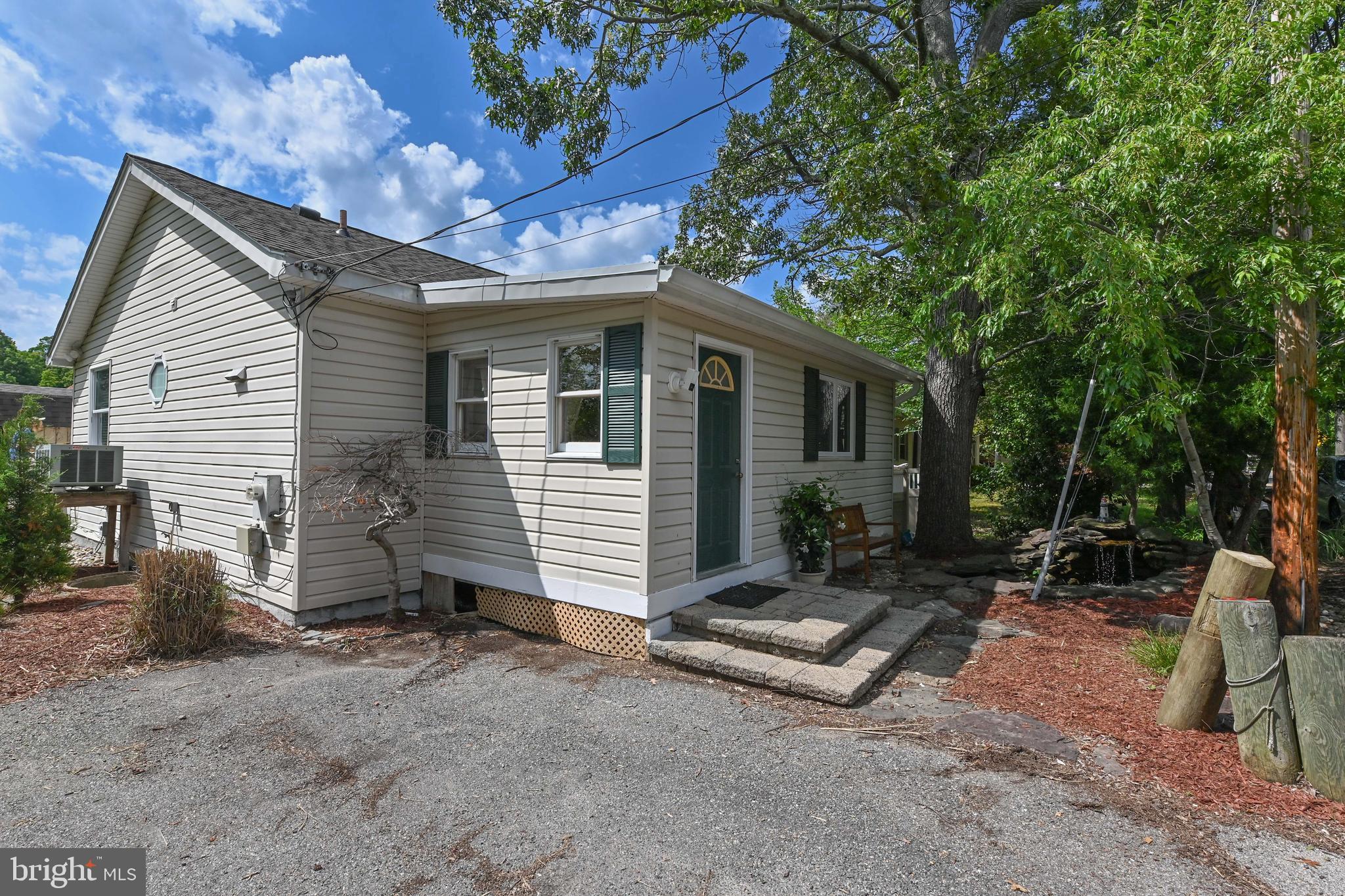 Welcome to this delightful coastal cottage nestled in the heart of the Columbia Beach community! Spacious wide beach, tot lot, tennis courts and basketball too. This beautifully updated home perfectly balances modern comfort with timeless charm. Offering two spacious bedrooms and a full bath, the layout is thoughtfully designed for easy living and effortless style. Winter peek-a-boo waterview too!
Step inside to find gleaming hardwood floors and an updated kitchen featuring brand-new stainless steel appliances and generous storage space. New roof (2023). The new kitchen has stainless appliances from the range and hood to the refrigerator and oven. Kitchen cabinets with lazy Susan, contemporary hardware, and quartz countertops. New skylights and many brand-new windows. 5 ceiling fans. Situated on a picturesque level yard showcases lush landscaping in both the front and side, and a koi pond in the front. Best of all, is the back deck ready for entertaining or enjoying peaceful outdoor moments.
As a resident of Columbia Beach, you’ll enjoy exclusive access to the Chesapeake Bay—perfect for fishing, boating, or simply soaking in the serene waterside atmosphere. Community amenities include a private boat ramp, pier, playground, and basketball and tennis courts, enriching your waterfront lifestyle. Sit on the new deck and watch the sunsets, or grab your kayak and go to the community beach, or even closer, Franklin Point State Park. Swim, tan on the sand beach, or go fishing. So much new in this clean and updated Columbia Beach cottage.
This isn't just a home—it's a lifestyle. Don't miss your chance to own a piece of Chesapeake Bay charm. Schedule your private tour today!