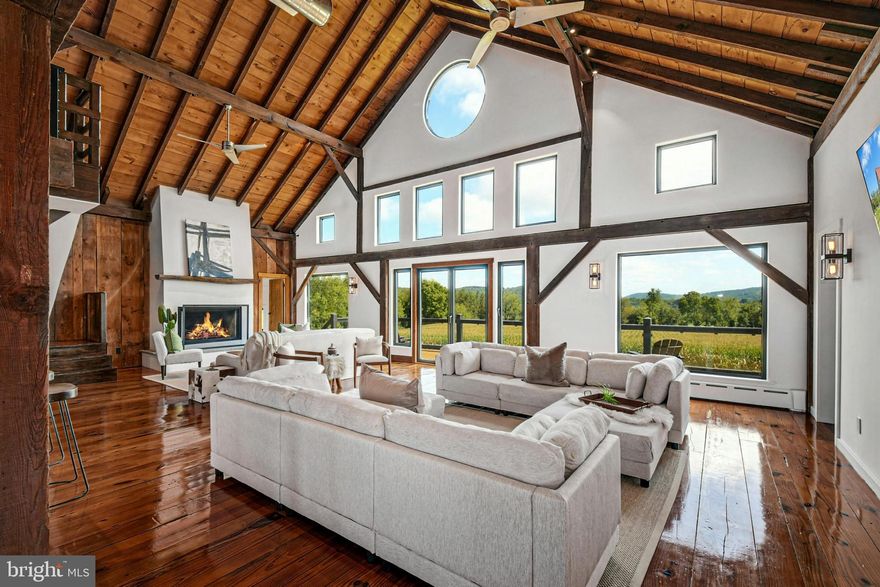 The very essence of a Bucks County gentleman’s estate is evidenced at first approach…turning off a quintessential country road, meandering down a long, tree-lined drive, all surrounded by breathtaking views of the Durham countryside that include long distance vistas over the Delaware River Valley. Sequestered on 90 acres, the setting is a unique and timeless representation of the magic for which Upper Bucks County is famous. 
Spring Hill is a rare and beautiful example of a barn renovation with re-imagined vaulted spaces, blended with stunning new architectural details, re-purposed barn beams, and antique wood. The seamless blend of original features and new renovations amazes and delights. These rich patinas, combined with incredible space and light, are testament to the skill and execution of the owner/architect.
Spring Hill sets the bar for every romantic estate and may be the best property you will ever see. The buildings and pool have been perfectly positioned, amidst the rolling acreage, overlooking views of manicured farmland, gardens, and specimen plantings…all beckoning morning walks and sunset contemplations. 
Designed to enhance beauty and livability, the sun-filled spaces offer panoramic vistas of protected environs. There are amazing spaces in which to entertain in large numbers. Six bedrooms and nine baths invite family and guests, and a separate guest apartment will pamper all, while providing a comfortable space apart. Additionally, 9 car garaging invites car enthusiasts and collectors alike. The heated pool, spa and adjacent pool house are dramatically positioned amidst the serene views. For the horse enthusiast, the property is a blank canvas for future equestrian pursuits.
Spring Hill is one of the jewels of Bucks County, in an exquisite and secluded setting. Every aspect, both inside and out, is presented artfully and joyfully. This private paradise loses touch with the world just over the hills yet is still within easy driving distance to the magic of Bucks County dining, antiquing and recreation.